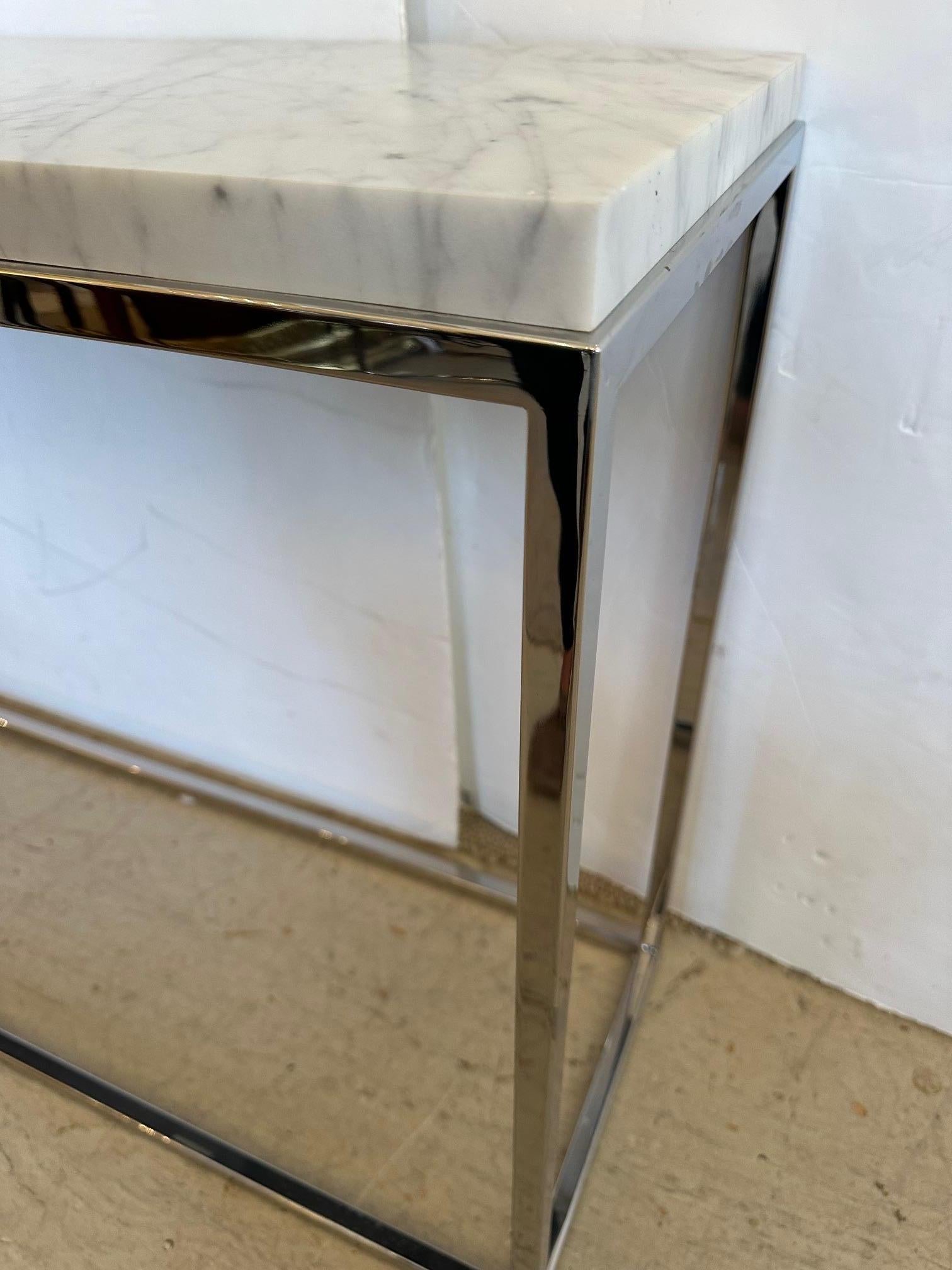 Classic streamlined sophisticated chrome and marble top console table.