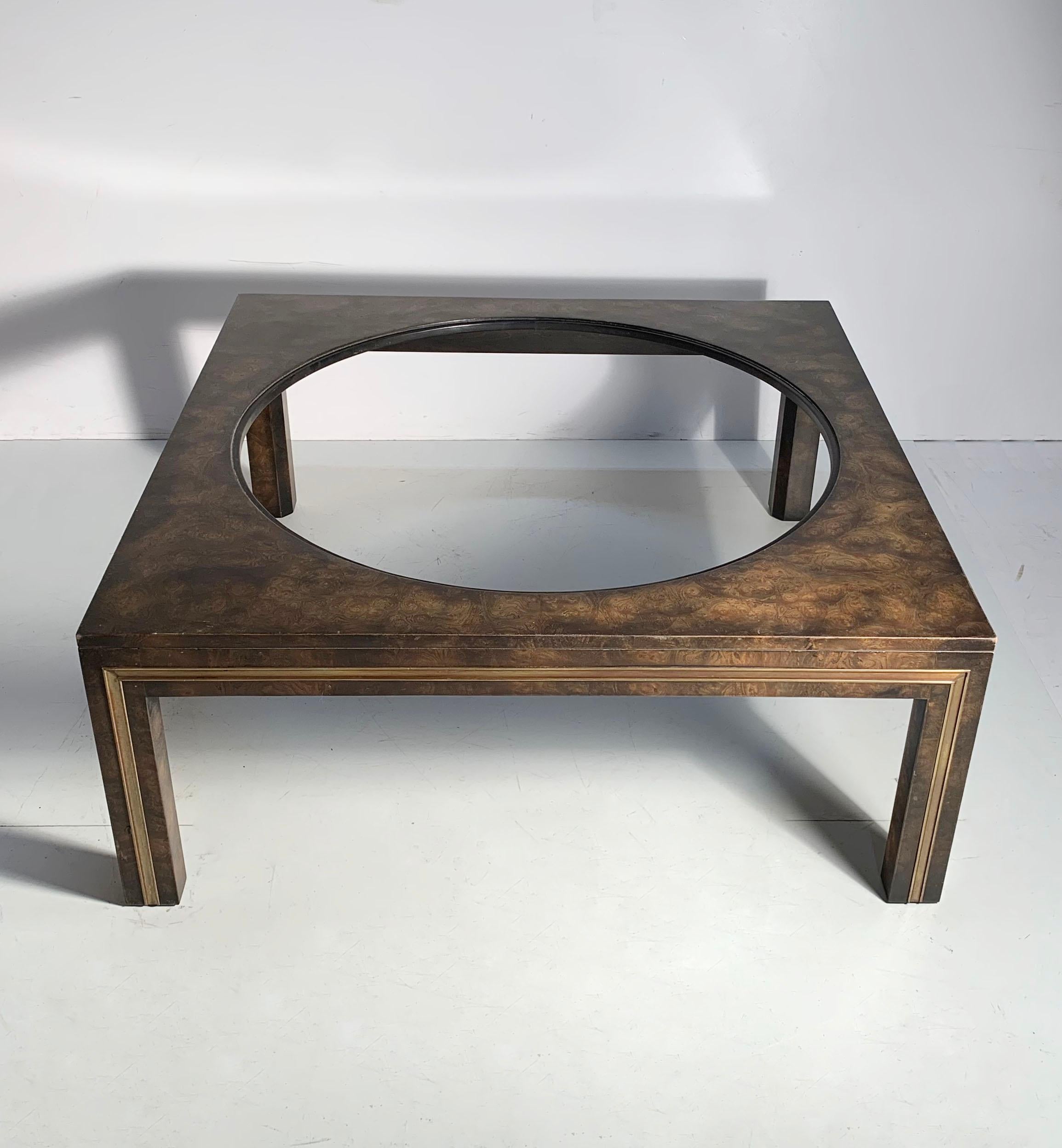 This coffee table has a big designer die-cut hole for a glass insert. Gives the table some edge. Manner of Milo Baughman.
 