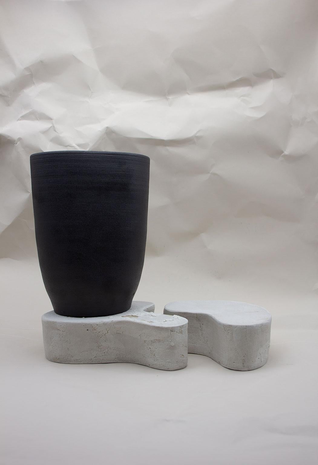 The Black Void vase and two plinths blurs the boundary between a functional vase and a sculptural object. Created as part of the Soft, Soft Hard 2018 collection, these pieces are an exploration into form and the relationship between the wheel and