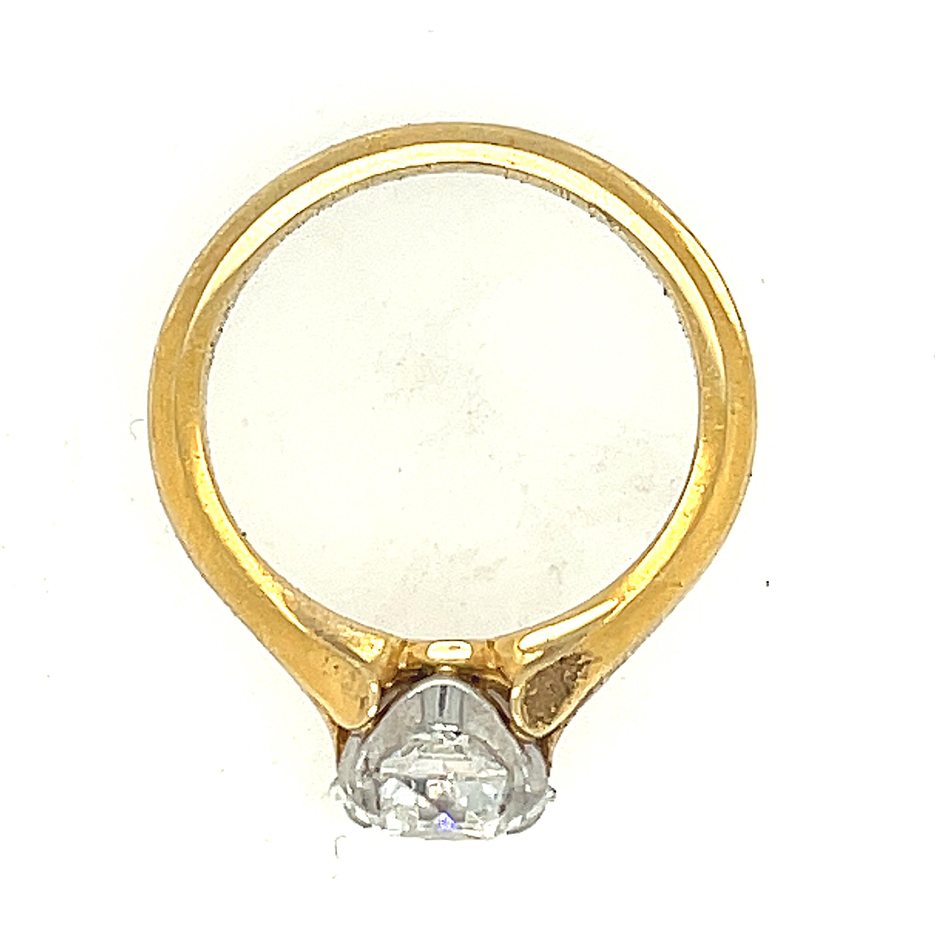 A charming antique cut diamond ring set in an 18k mounting by McTeigue & McClelland, circa 2000. The ring centers on a diamond weighing 1.43 carats and is certified by the GIA as an F Color and VS1 clarity. The diamond is set in platinum, however