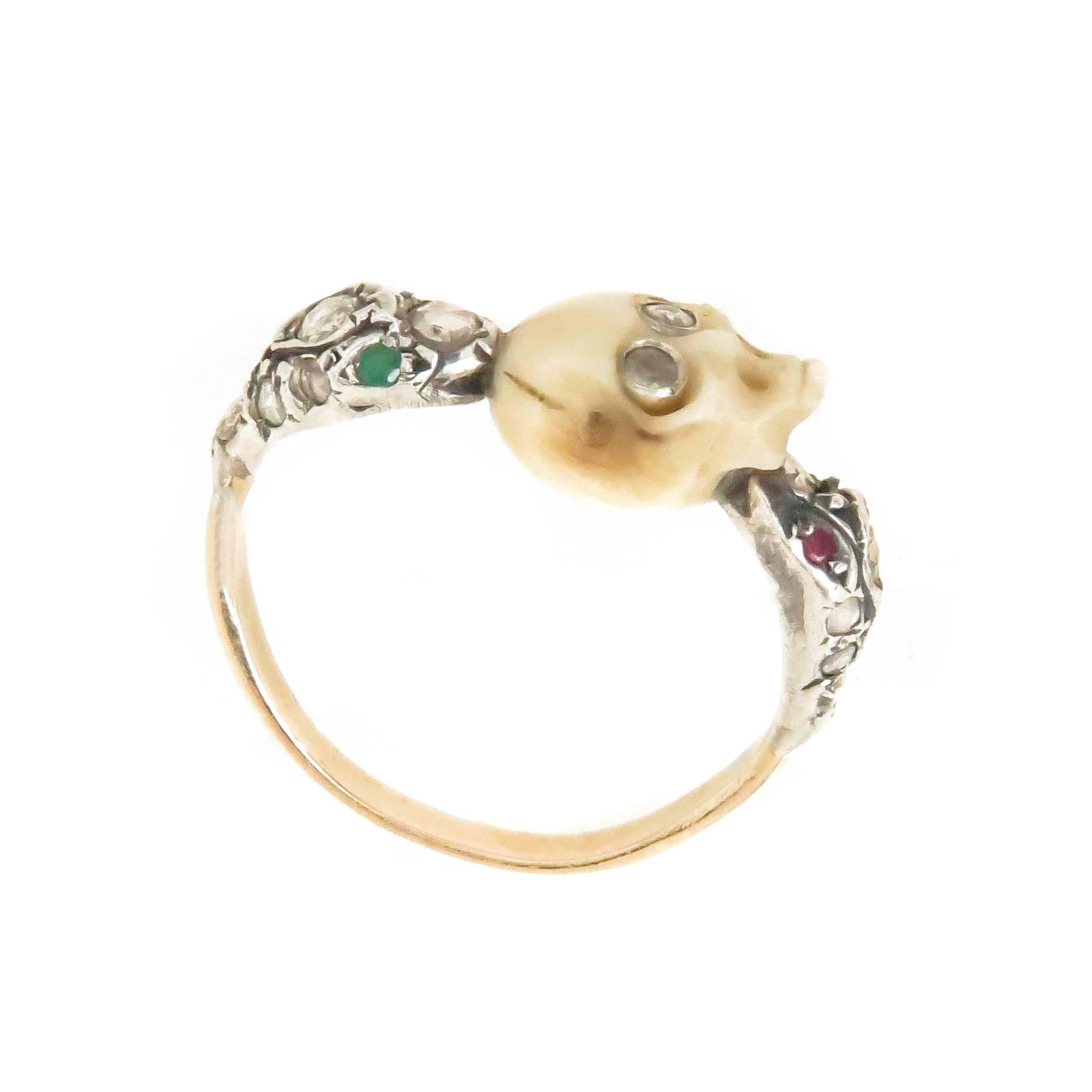  Memento Mori, Memorial Ring, Silver top and yellow Gold. Rose Cut Diamonds and Gem stone eye Serpant Heads hold a carved Bone Skull with Diamond eyes, the skull measures 3/8 X 5/16 inch and the ring measures 7/8 inch across the top. Finger Size 5