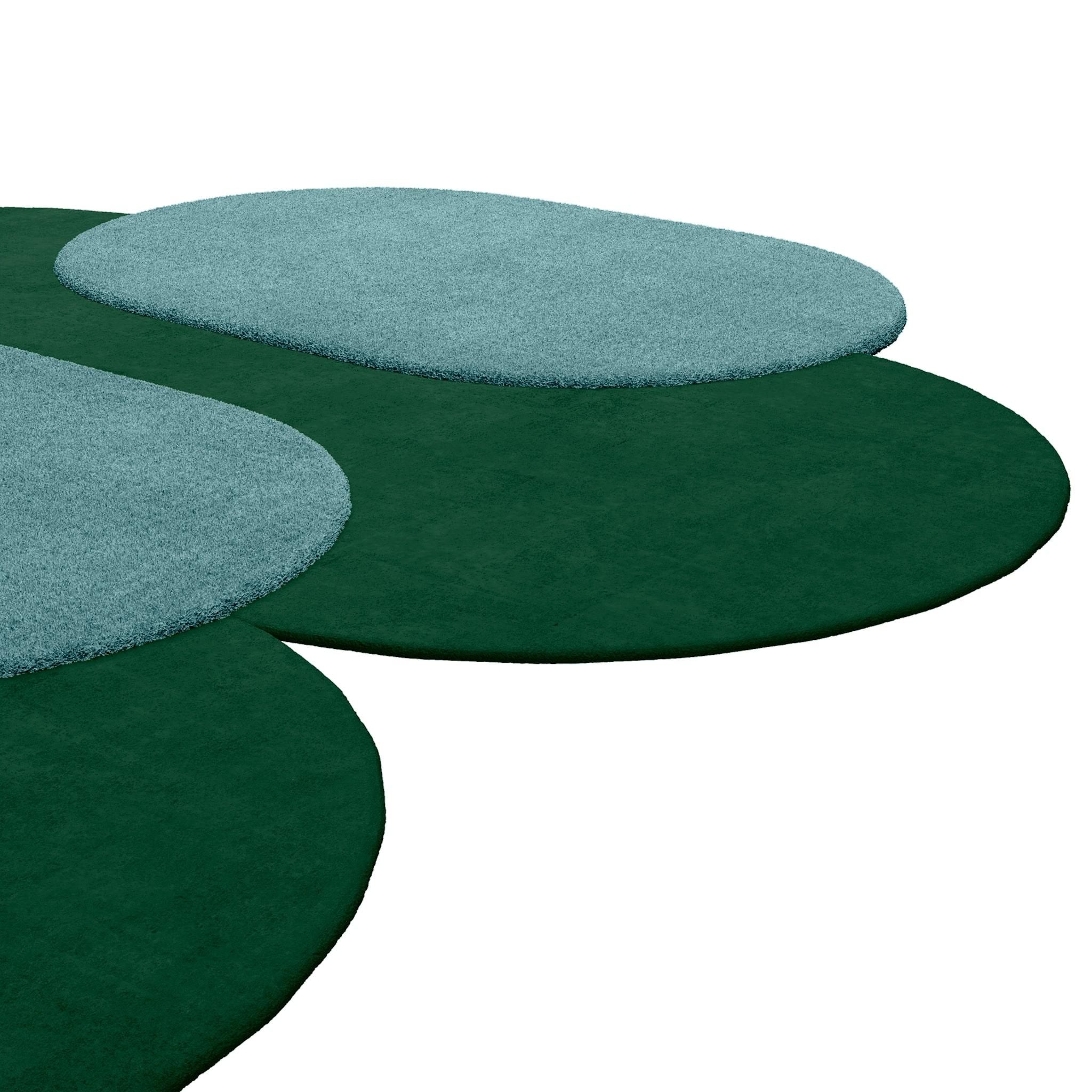 Tapis Shaped #048 is a Modern style rug in murky green and light blue, a classic yet sophisticated color combination.
With an irregular shape that juxtaposes oval circles with contrasting colors, this is a design masterpiece that makes a statement
