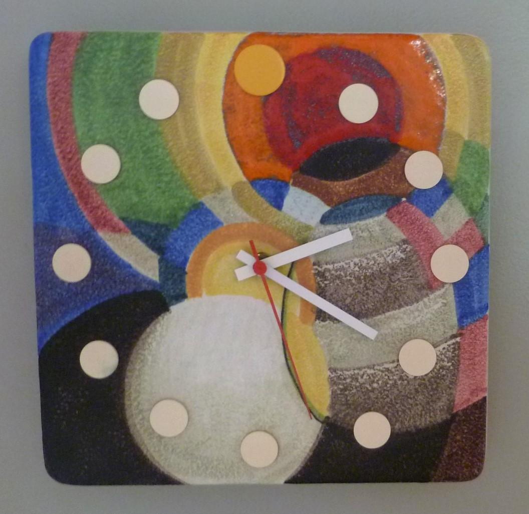 A rarely seen Mid-Century Modern Italian ceramic wall clock from the Howard Miller Meridian collection. This particular colorful abstract design clock was made towards the end of the Meridian clocks production, which ended in 1974. It features a