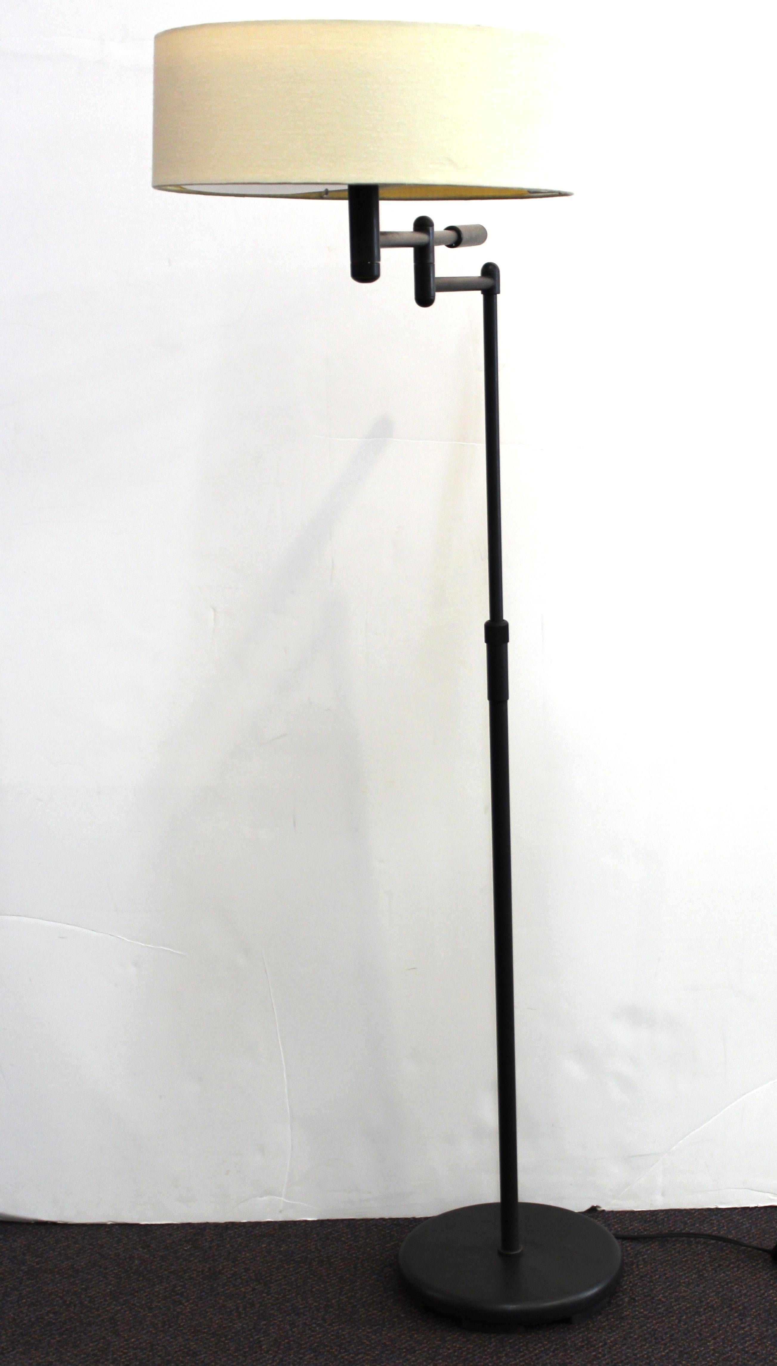 Modern metal floor lamp with articulated arm and original shade, with composite plastic mesh light filters. The piece was made in the mid-late 20th century and is in great vintage condition.