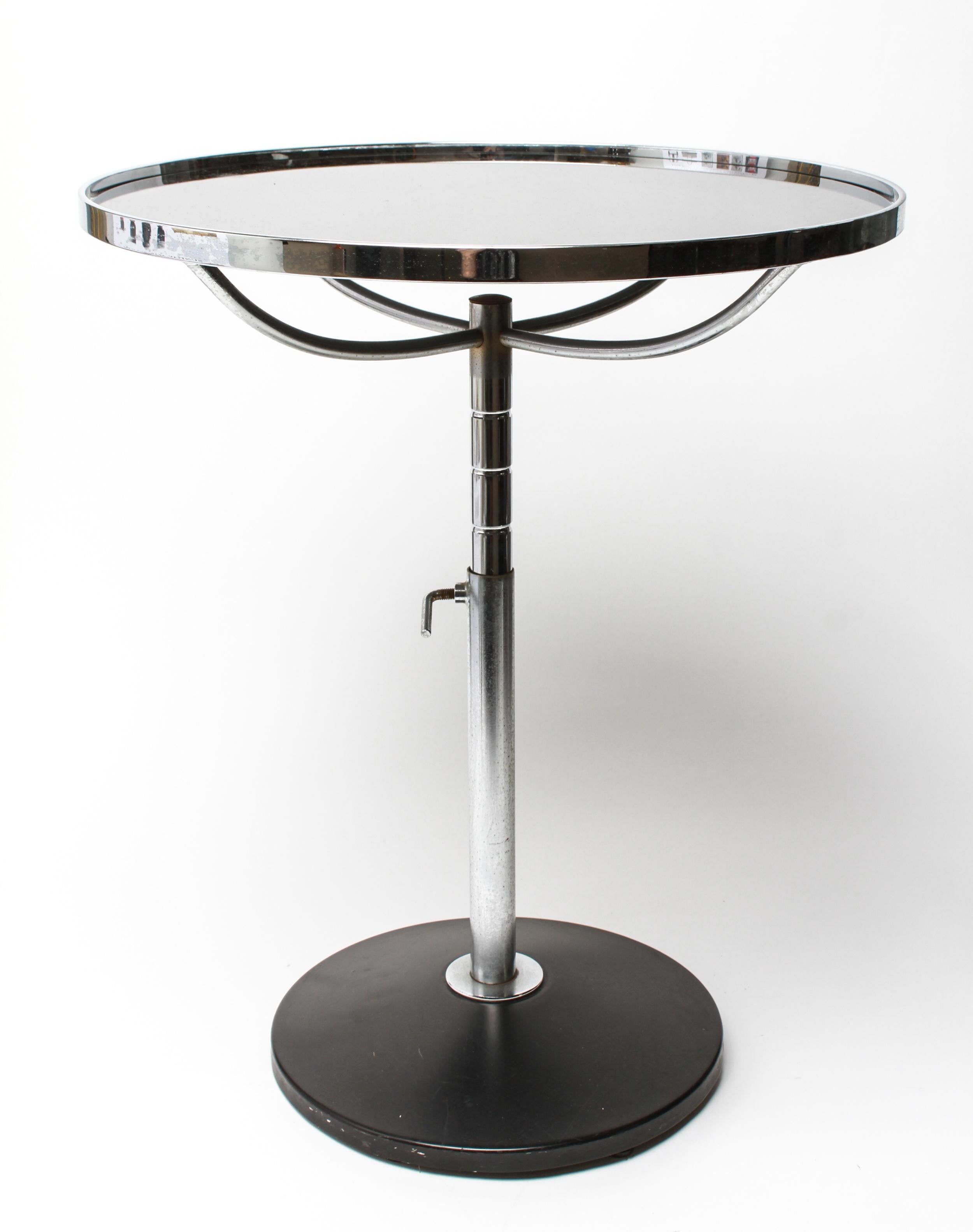 Modern metal adjustable height round top side table with an inset with a black glass top and a chrome metal frame. The piece is in great vintage condition with age-appropriate wear.