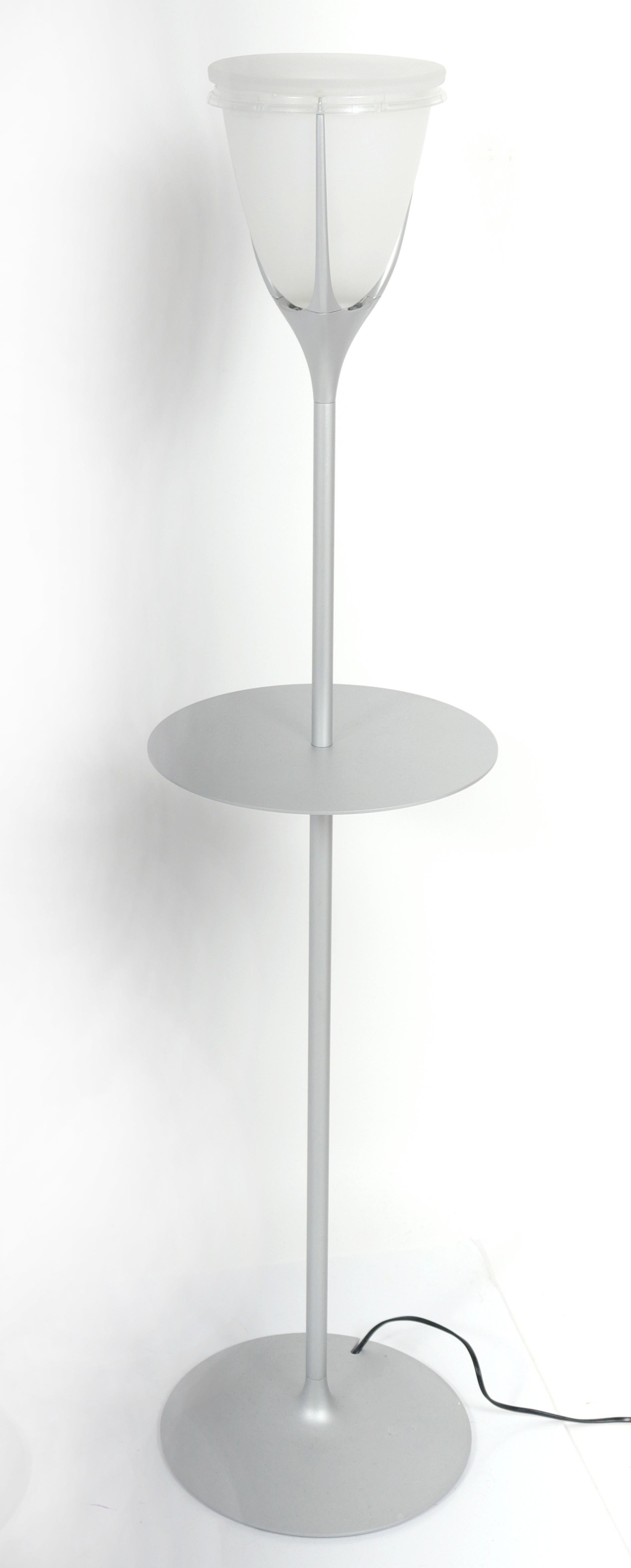 Pair of modern metal floor lamps with frosted glass shades and round shelves. Measures: 50.5