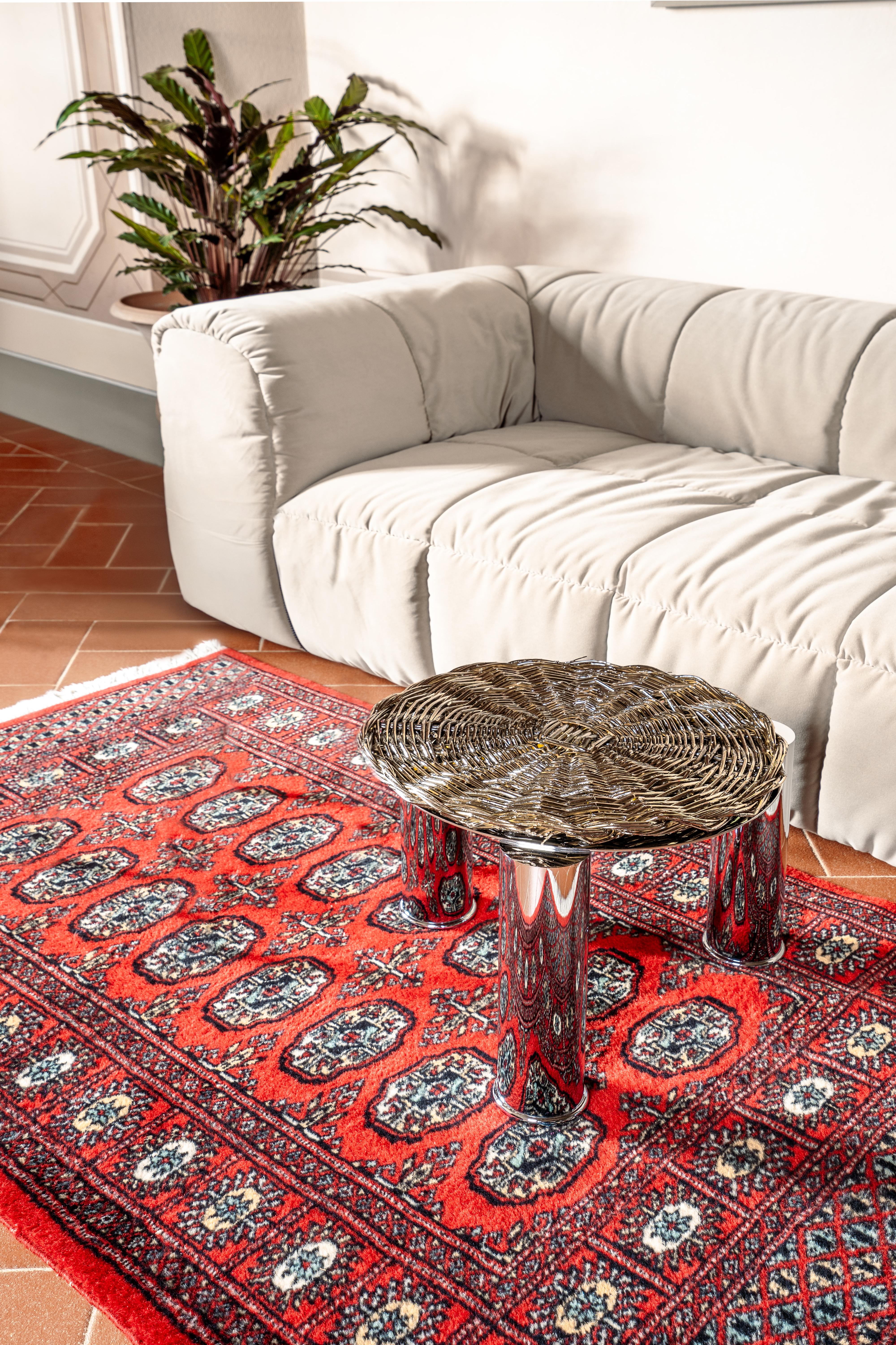 Set of 2  contemporary metal-plated coffee or side table is a collectible design piece crafted with exceptional care and artistry. The piece features a chromed steel frame and a top in Supermirror stainless steel, handmade woven using natural