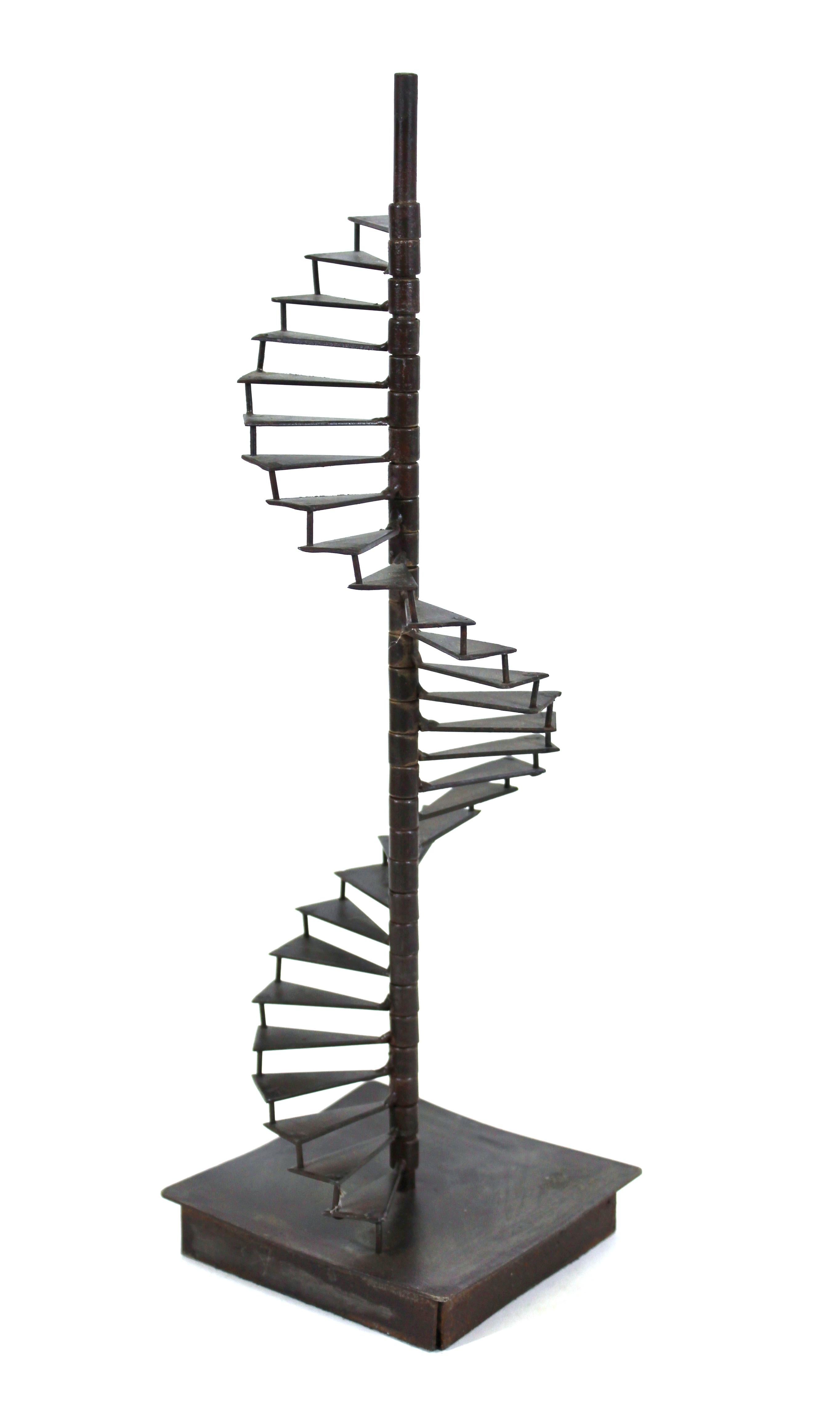 Modern scale model of a spiraling staircase in welded metal, mounted on square metal base.