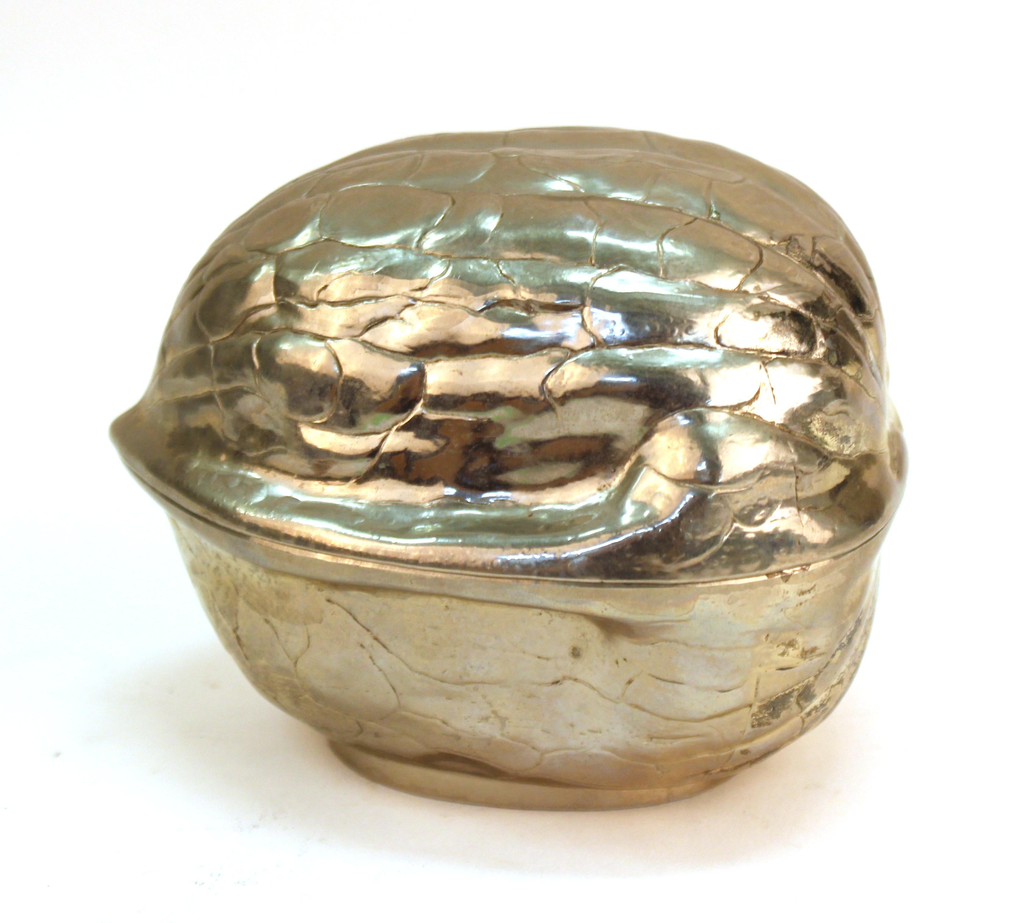 Modern metal trinket box in the shape of a walnut. The piece is in great vintage condition with some minor surface wear to the bottom.