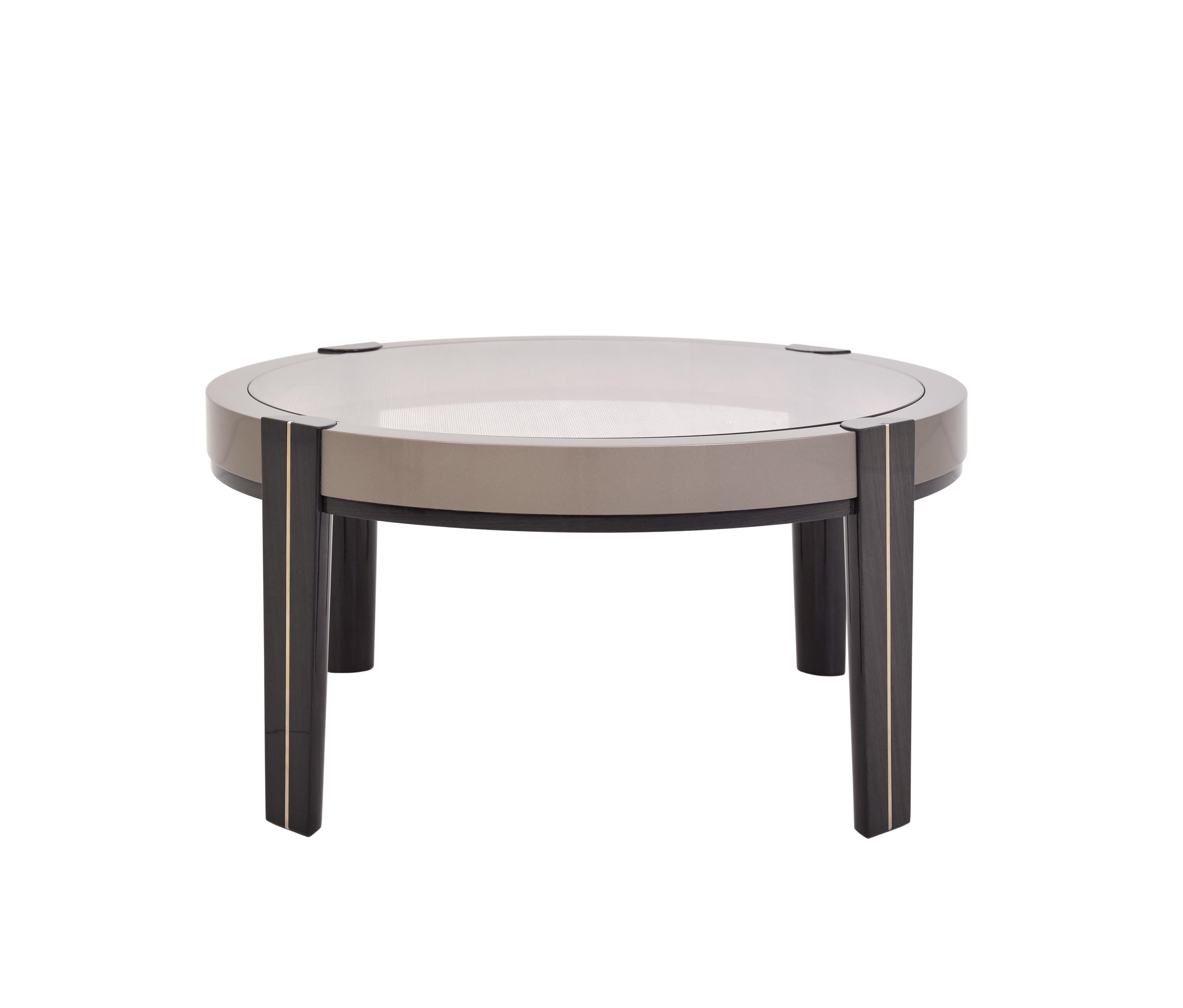 This modern round center table combines sleek sophistication with functional design, making it a standout piece for any contemporary living space. Featuring a luxurious glass top, the table is encased in a stylish colored frame that complements its