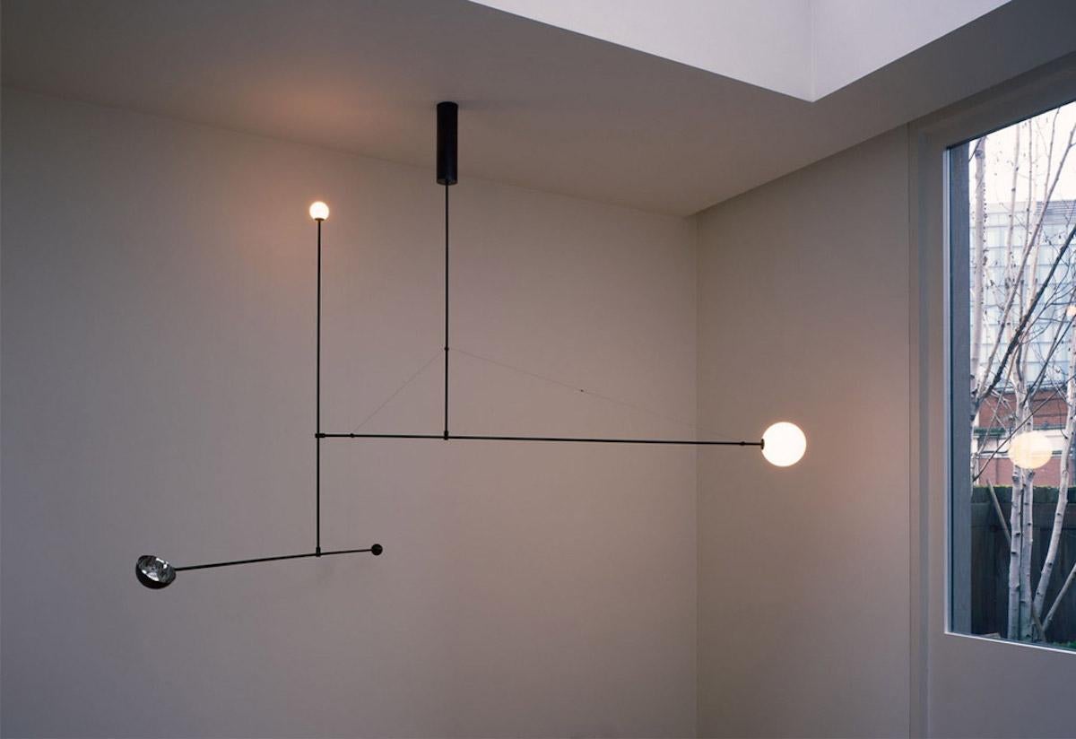 Michael Anastassiades Moble chandelier in blackened brass and mouth blown opaline spheres.
