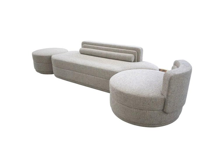 Modern mid-century modular curved grey sofa with side tables and gold details Cluedo sofa
This rounded sofa and its round ottomans offer a modern-chic vibe to any modern living room design. This piece provides a modern-chic vibe to your interior