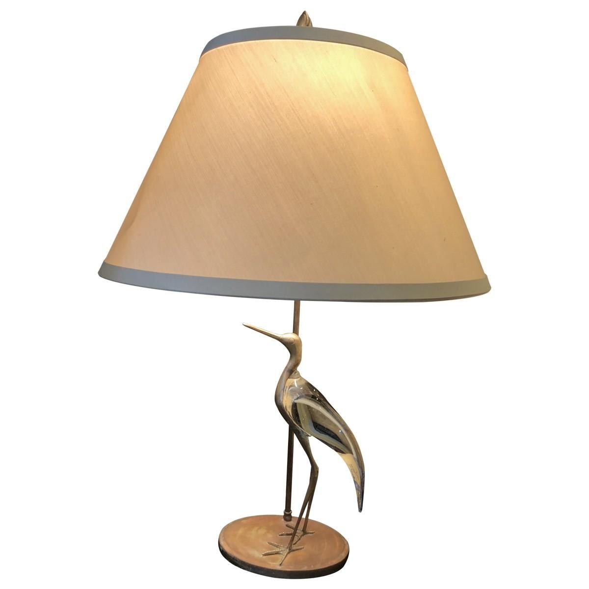 Bring a festive look to your living room or office with this whimsical avian lamp. A gold-tone Brass metal base glass gives the lamp added glamour. Does not include shade.
 