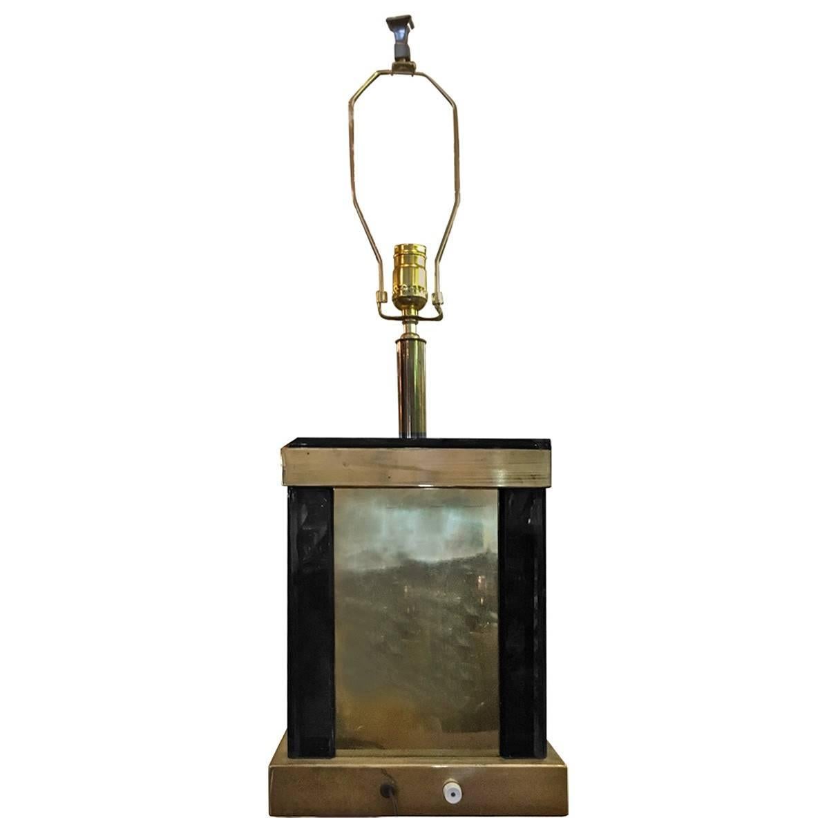Modern brass table lamp features a rectangular shape that presents a bold and sophisticated style that exudes handsome craftsmanship. A beautiful fixture, this lamp would be ideal for an end table or nightstand for both decorative and lighting