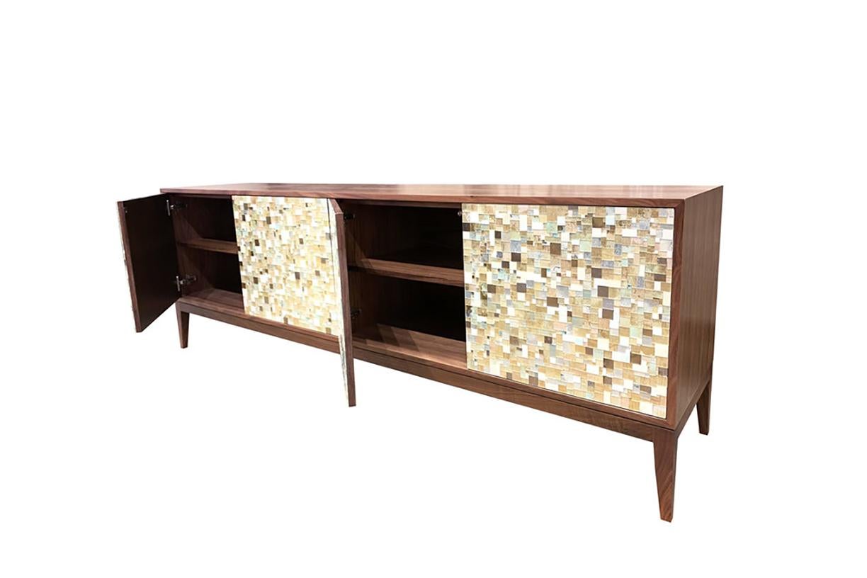 The Modern Milano Buffet by Ercole Home, with 4 touch latch doors within a Natural Walnut case. The doors feature hand-cut and hand-painted glass mosaic in our geometric Mondrian pattern. The glass colors include Ivory, Gold, Celadon, and Silver,