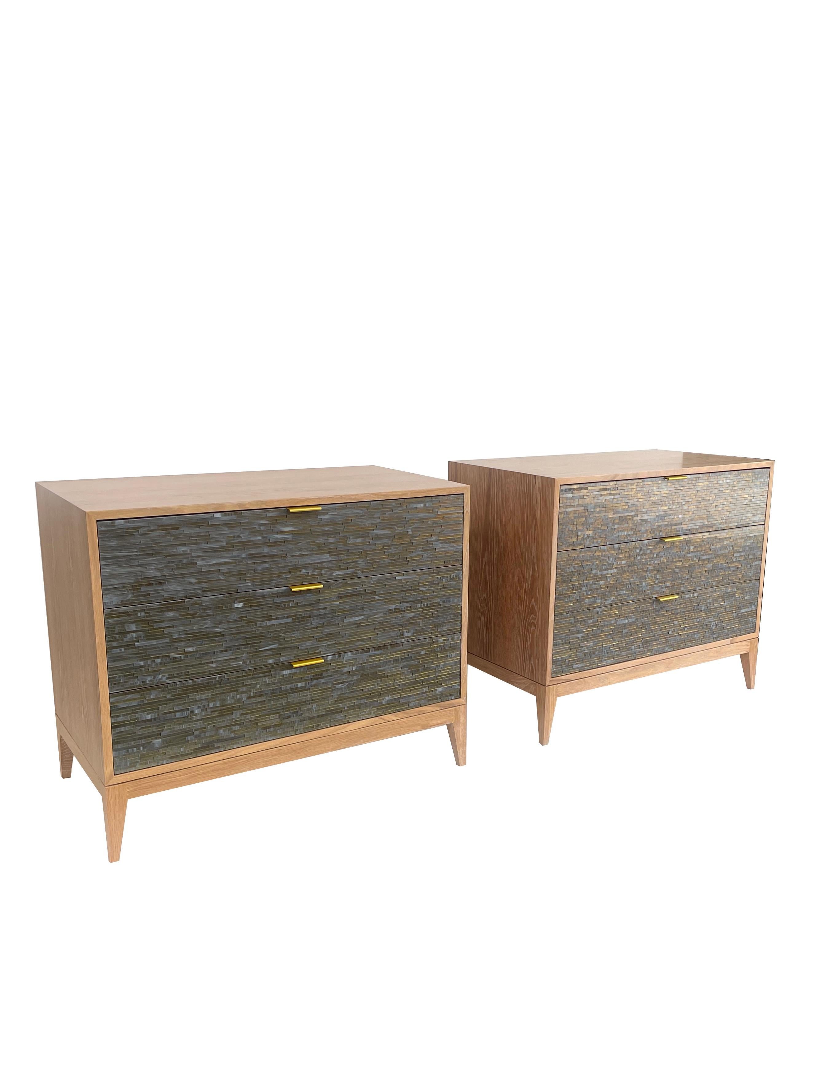 Introducing the Milano 3-Drawer Nightstand with Wispy Grey Gold Mosaic. Hand crafted with the utmost attention to detail, this exquisite piece features sleek wooden Milano legs in a Natural Oak finish. The nightstand's drawers feature a mosaic in
