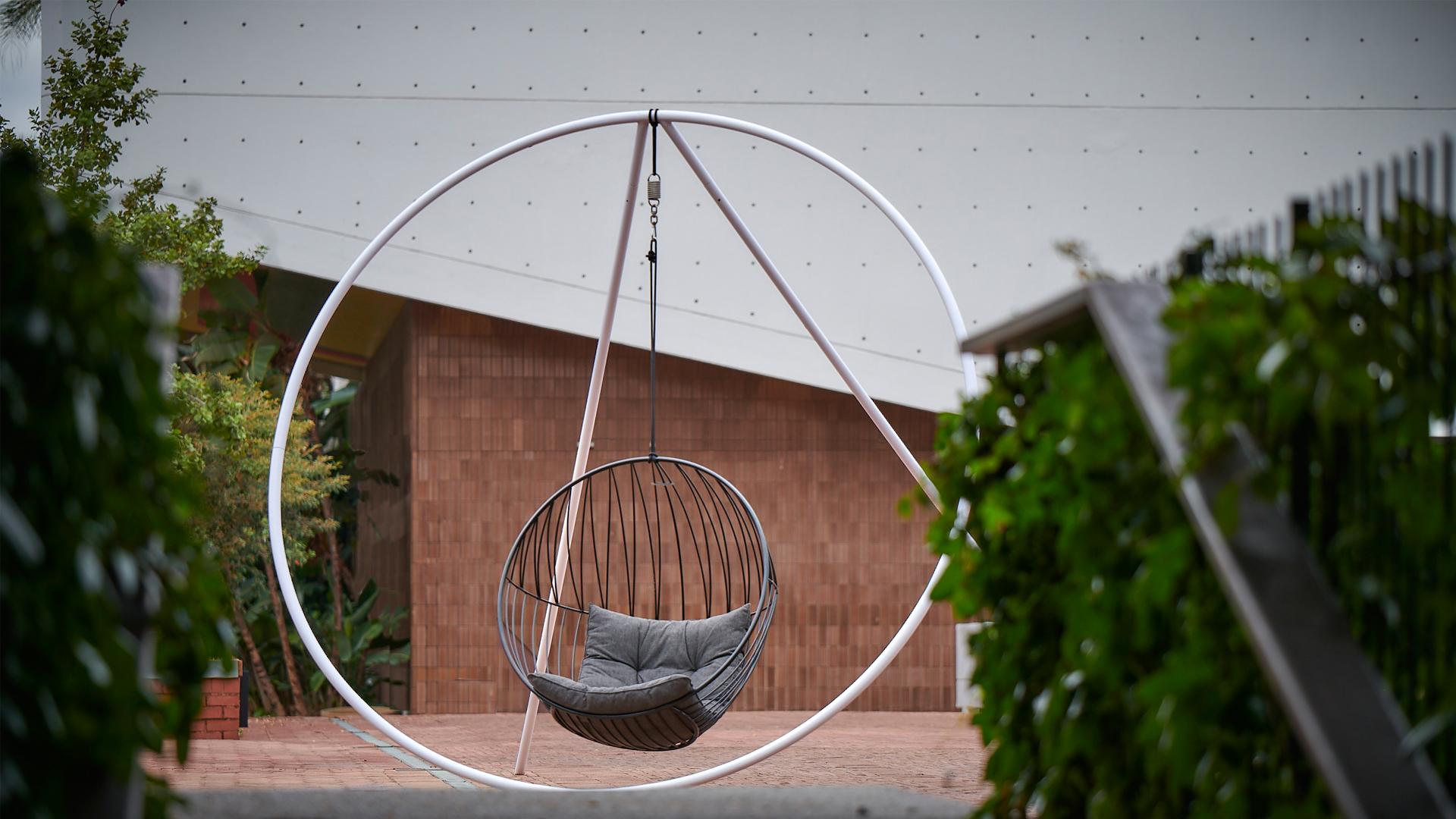 Contemporary Modern Minimal Outdoor Hanging Swing Chair with Stand and Cushions For Sale