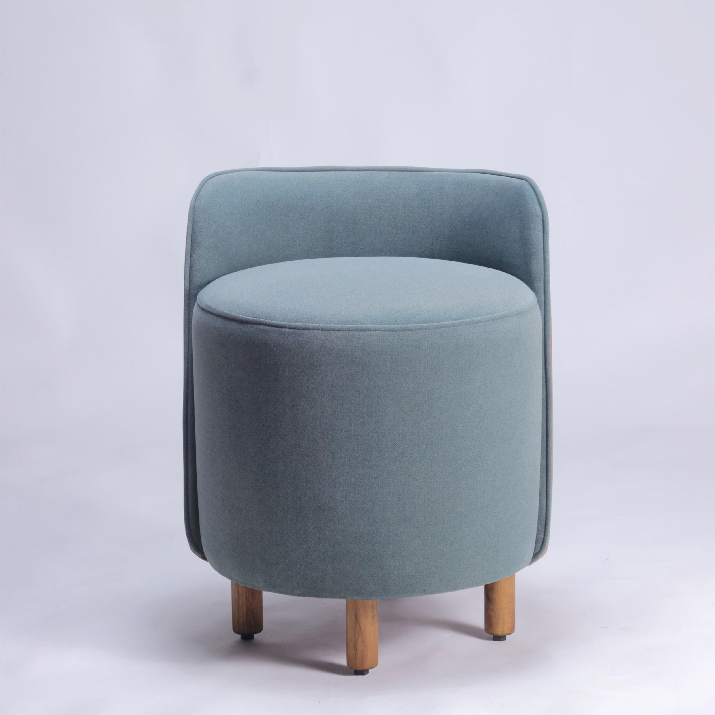 The Minpuff Pouffe is a modern and playful addition to any space. Crafted with solid wood legs, cushioned seat and a backrest, the Minpuff provides a perfect perch for a quick seat or as a footstool. The luscious upholstery creates an interesting