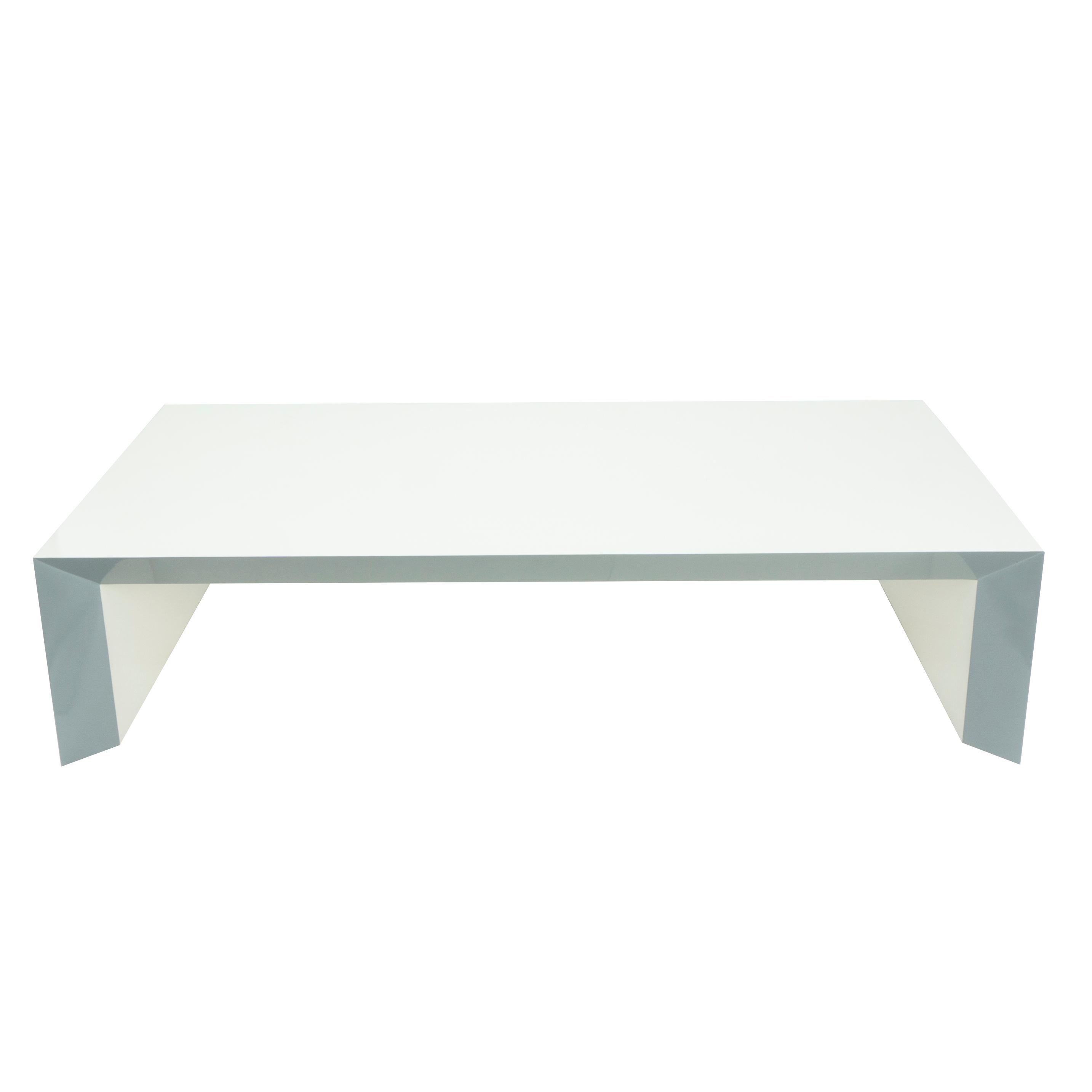 This modern and sleek coffee table is built to order and is customizable by size and finish. The table shown features a minimalistic design hand built and finished in white with soft grey accented beveled edges. 

Measurements: 16” H x 66” W x 36”