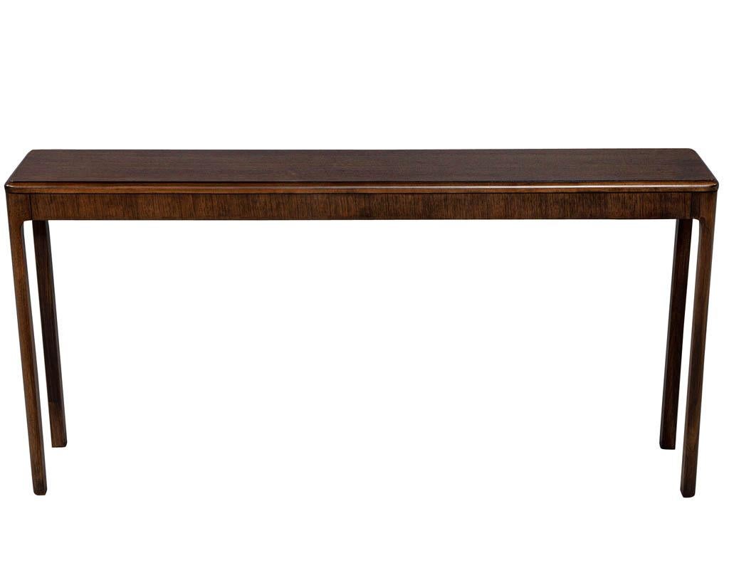 Modern Minimalist console hall table. Modern walnut console hall table finished in a satin walnut finish.

Price includes complimentary curb side delivery to the continental USA.