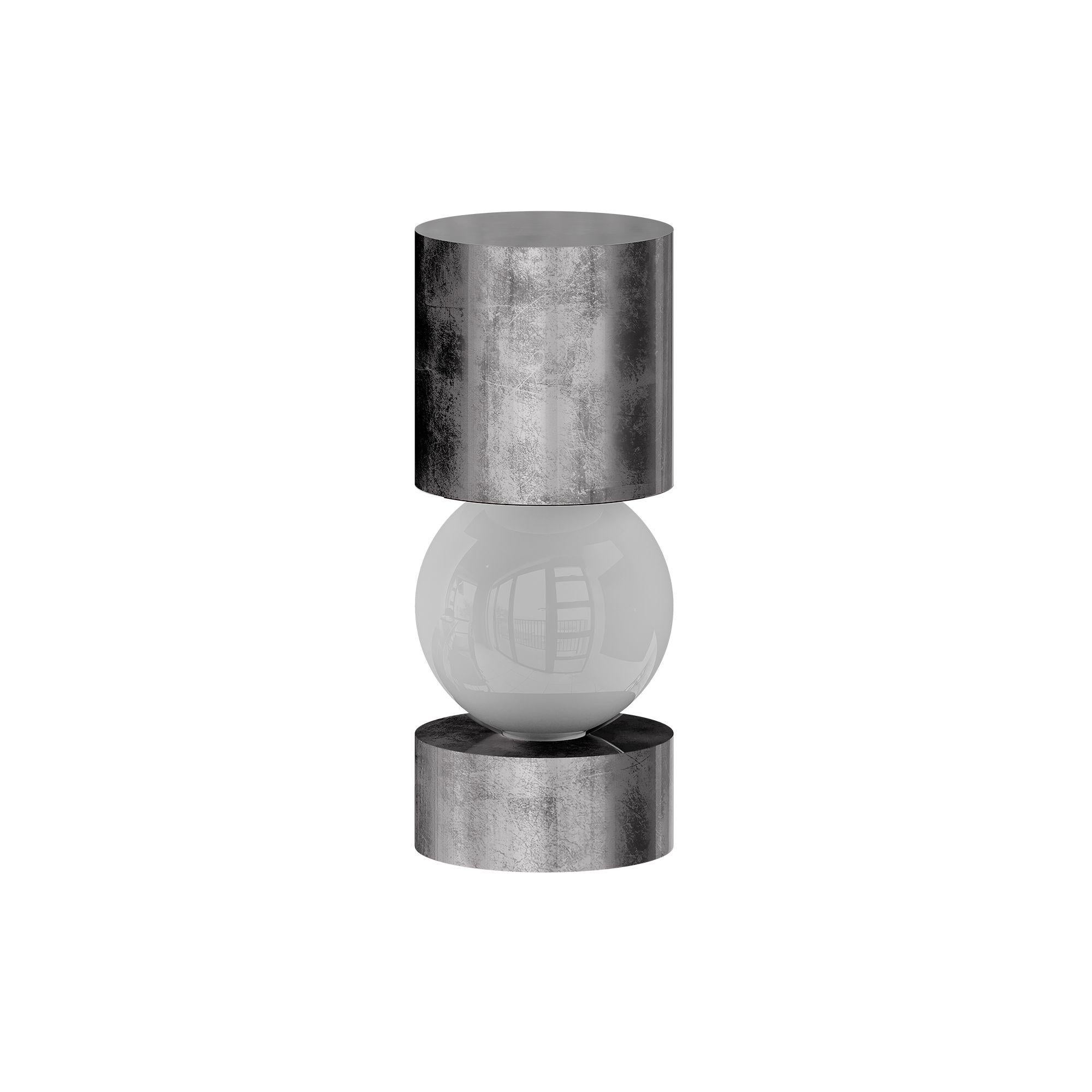 Mid-Century Modern Table Lamp, Geometric Shape Silver Leaf & Frosted Glass Light
The Athena Table Lamp Silver radiates sophisticated brilliance, combining geometric shapes with a hand-applied silver leaf finish. Its intersecting silhouette captures
