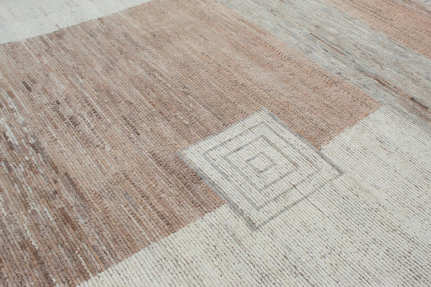 This is a beautiful modern rug that consists of 100% handspun and handcarded wool making it extremely durable. It has a very minimal design featuring geometric elements making it suitable for an array of settings. There are beige, tan, copper, and