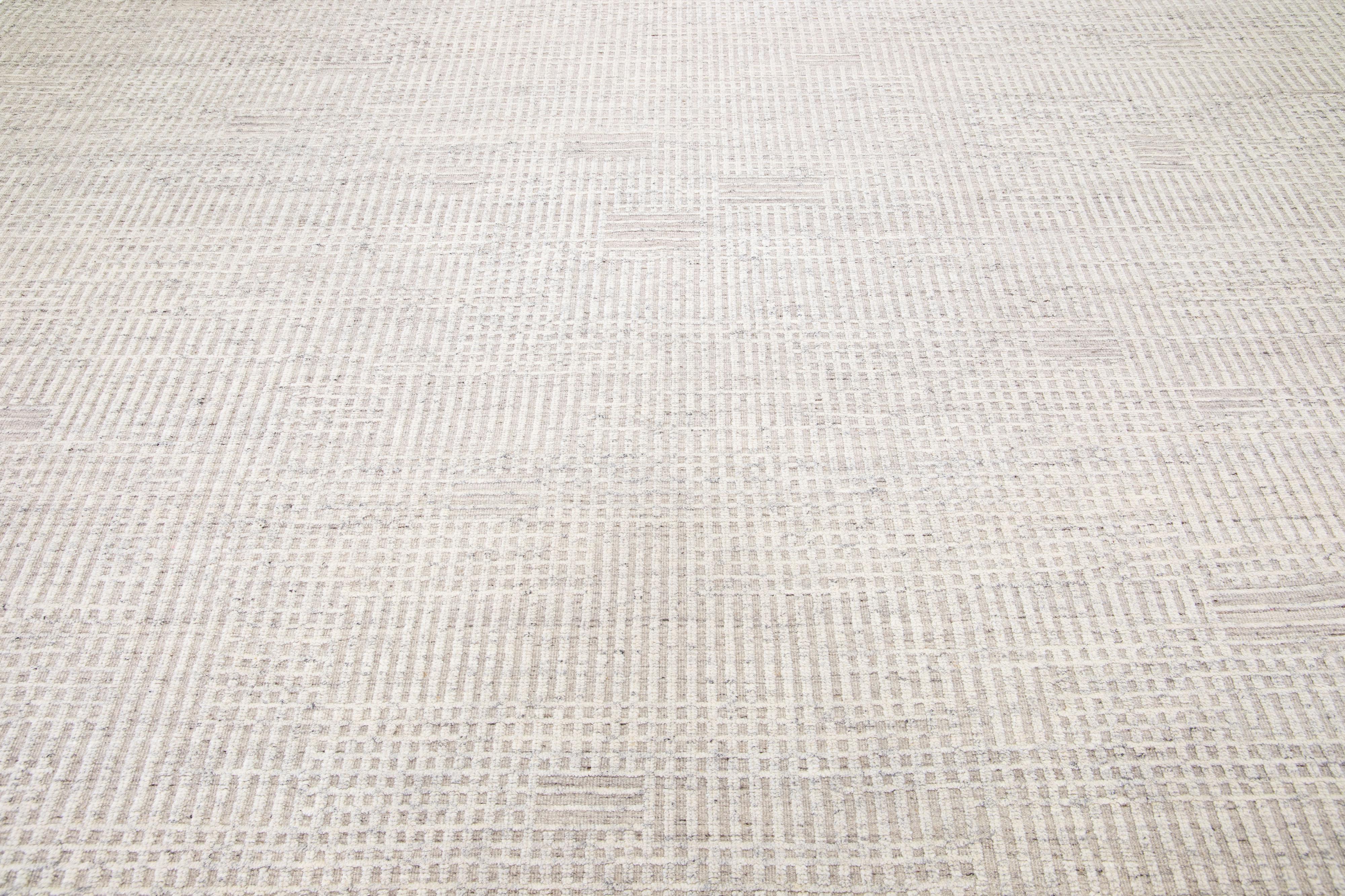 Beautiful modern Moroccan-style hand-knotted wool rug with a beige color field. This rug is part of our Apadana's Safi Collection and features a minimalist design in white and gray.

This rug measures: 12'3