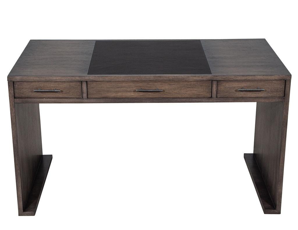 Modern minimalist oak leather top writing desk. Simplistic modern styling with beautiful textured Oak woods. Finished in a distressed grey wash finish with Italian black leather writing area. This sleek modern desk still offers great storage with