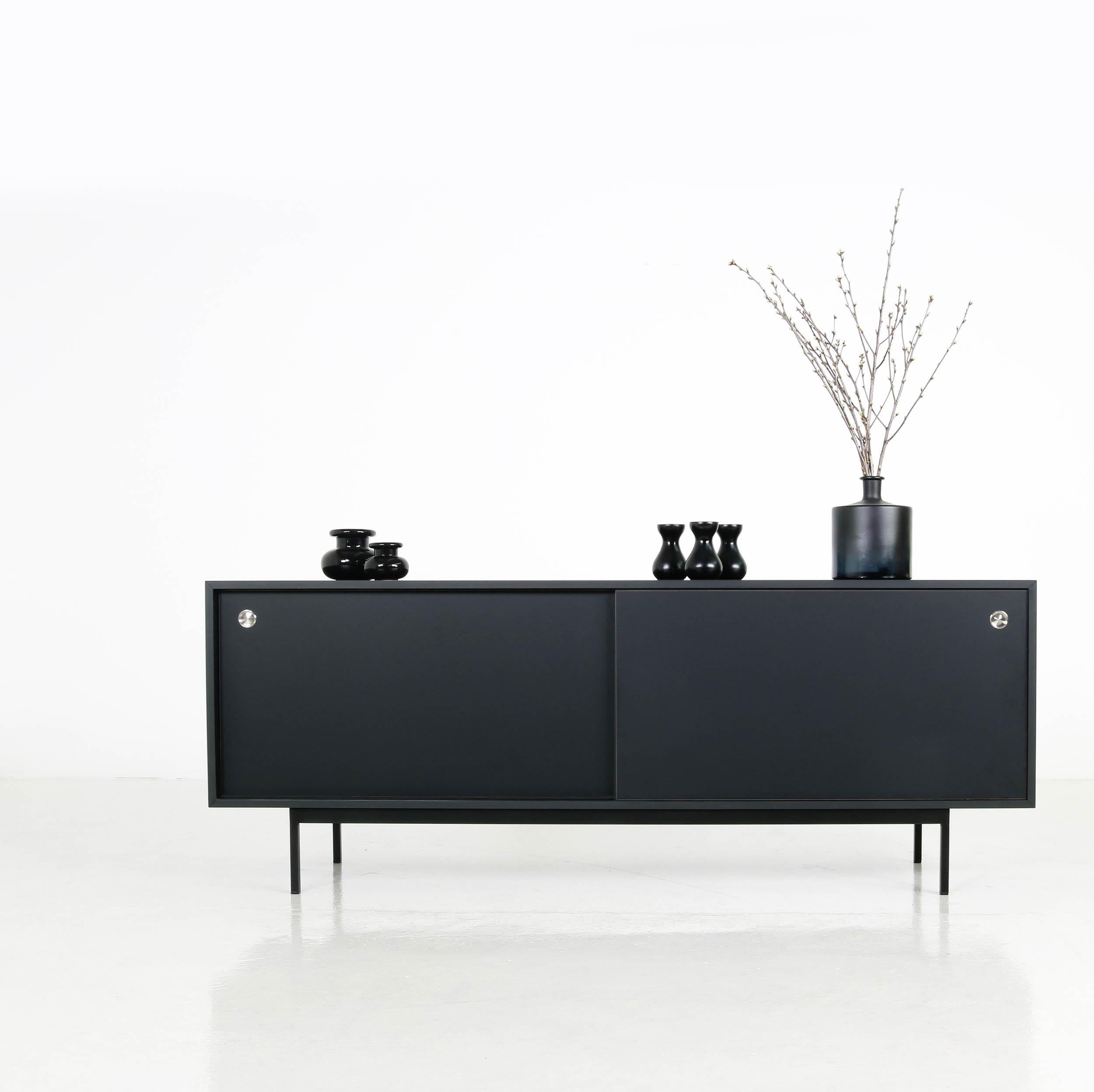 Beautiful sideboard, freestanding, made in Germany, design by Nathan Lindberg (Nathan Lindberg Design) Black HPL (Formica) body in matte, with sliding doors in black (painted or formica covered in black, depending on stock) with stainless steel door