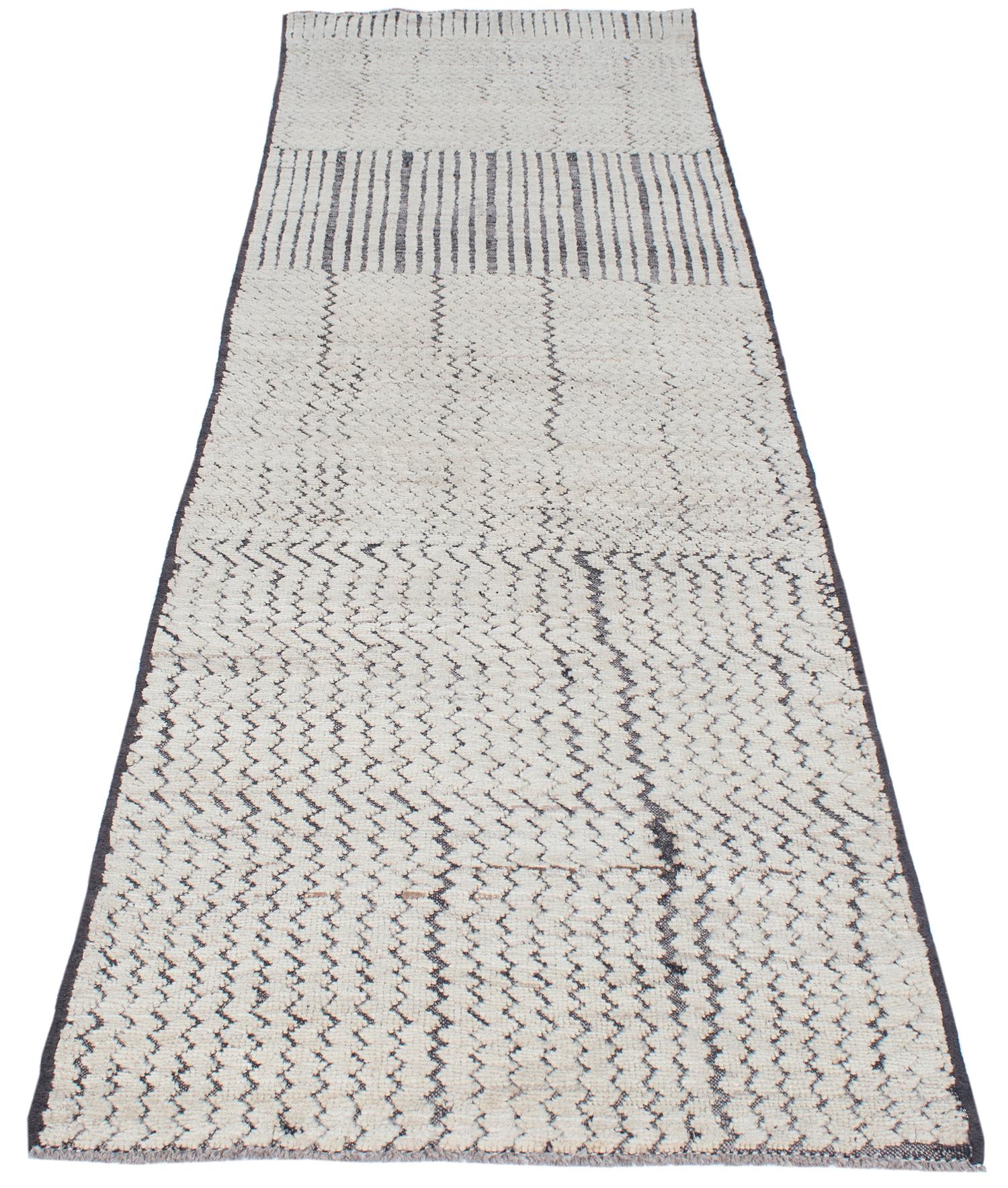 This is a beautiful runner made of 100% handspun and handcarded wool, entirely undyed. It features an abstract design titled 