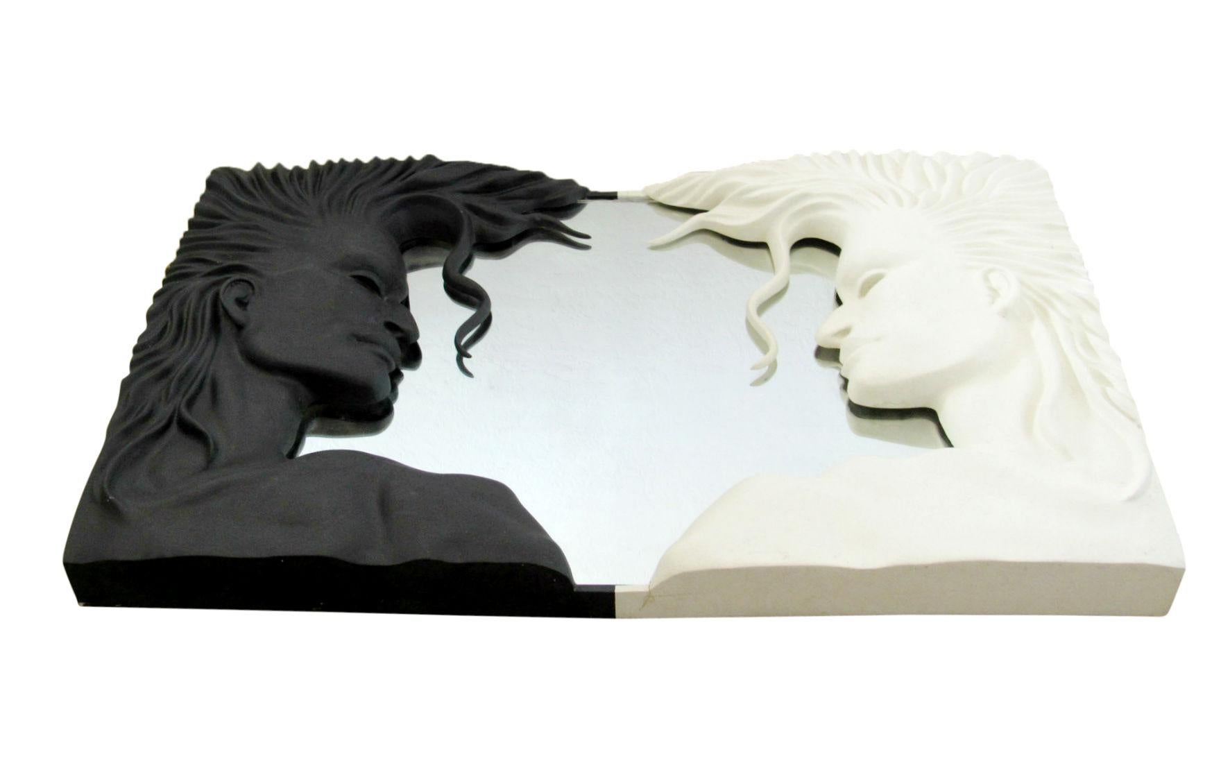 The 1980s are alive in this cool sculptural mirror constructed of fiberglass and featuring the profile of a man in black and white. Large scale and exceptionally well made. Unmarked.