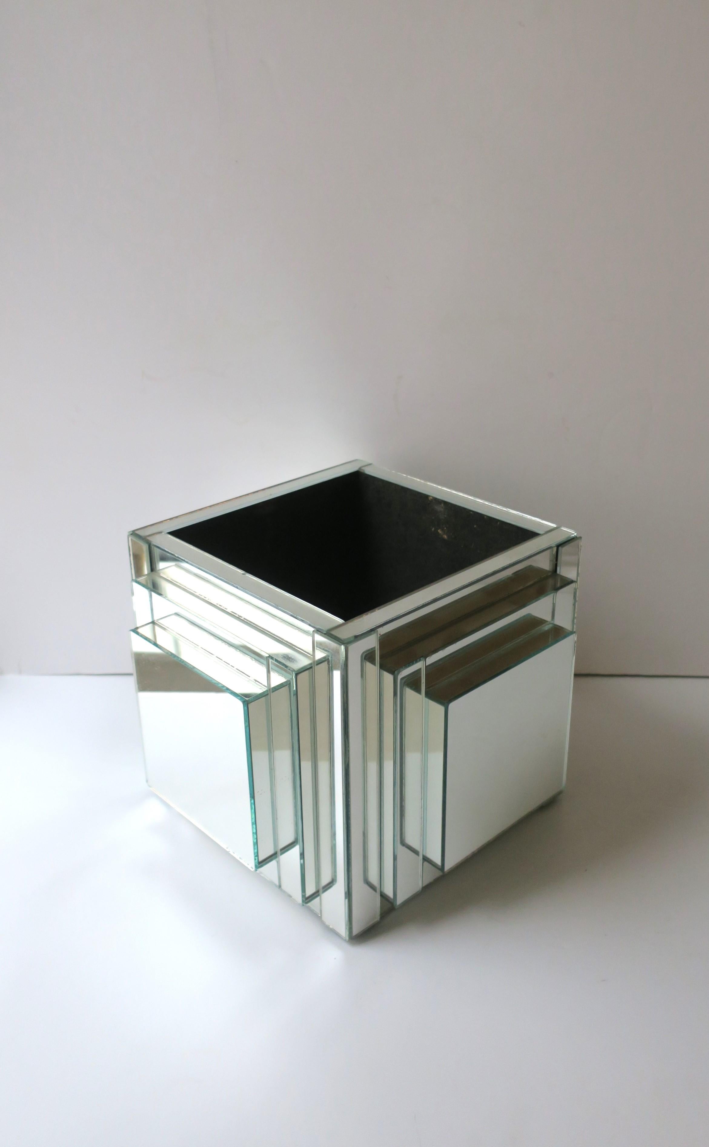 A substantial square mirrored planter cachepot jardinière, '70s Modern/Postmodern period, circa 1970s. Entire piece is mirror with a graduated design. A great piece for a plant or flower, low or high. Piece is strong and can handle a taller plant