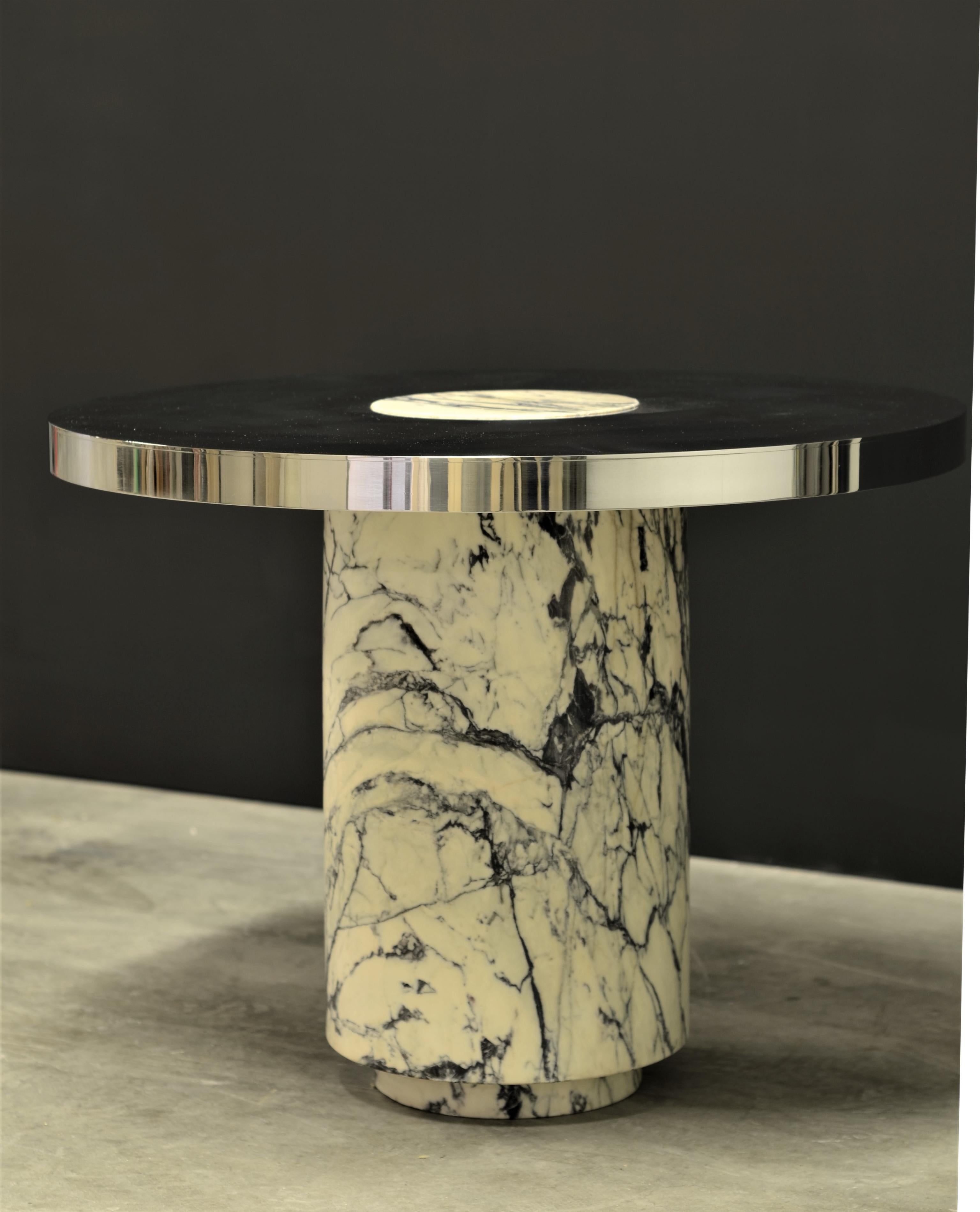 Impressive and smart circular table with a mirror finished stainless steel top and solid Paonazzetto marble base.

The top and bottom of the base have been narrowed, the narrowed top sticks thru and sits flush with the mirrored stainless steel