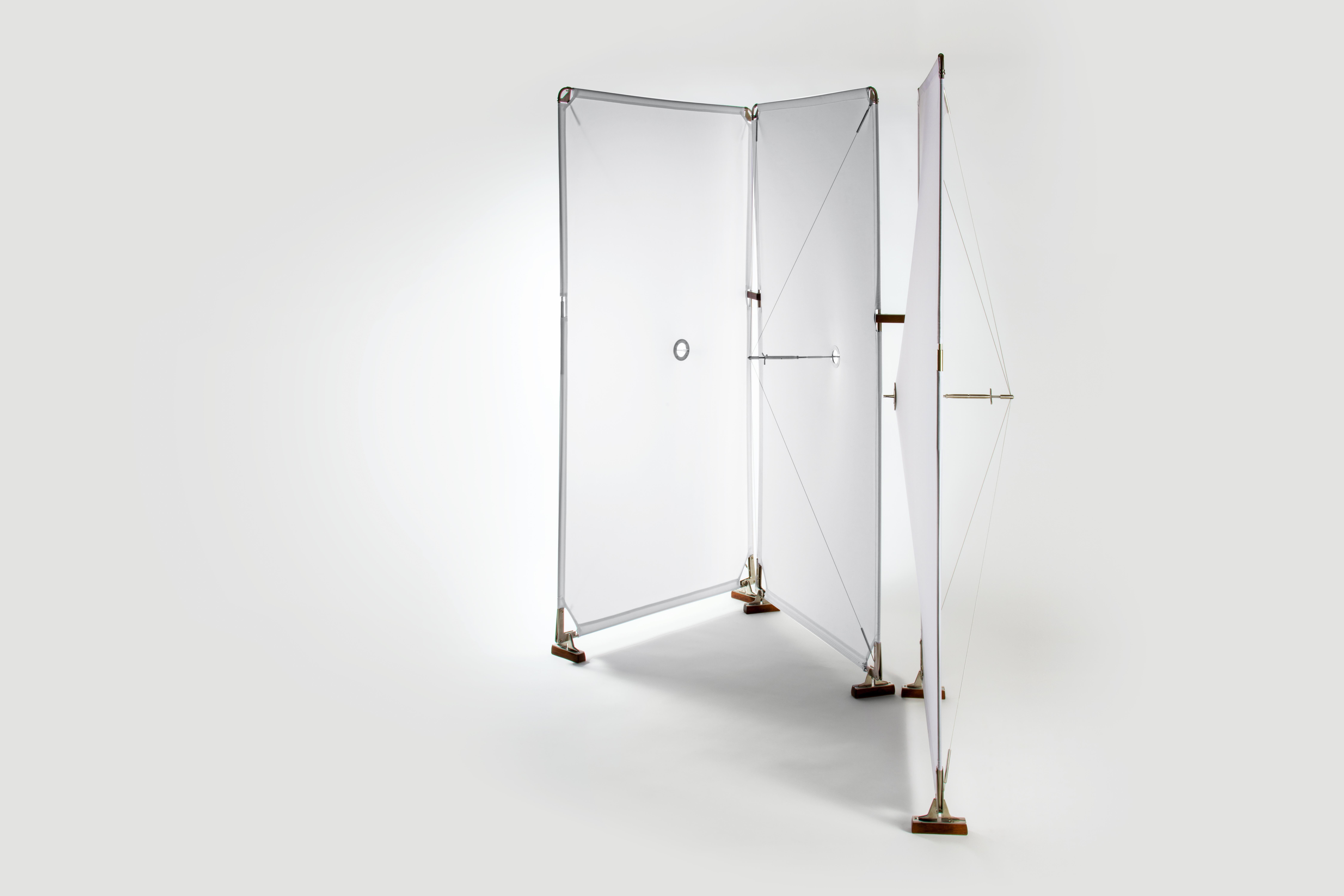 The Room divider is a fusion of lightweight materials and simple engineering. Its delicate frame, supported by a tension system reminiscent of the sleek lines of a yacht's sail, ensures stability with a subtle elegance.

A neat roman screw, subtly