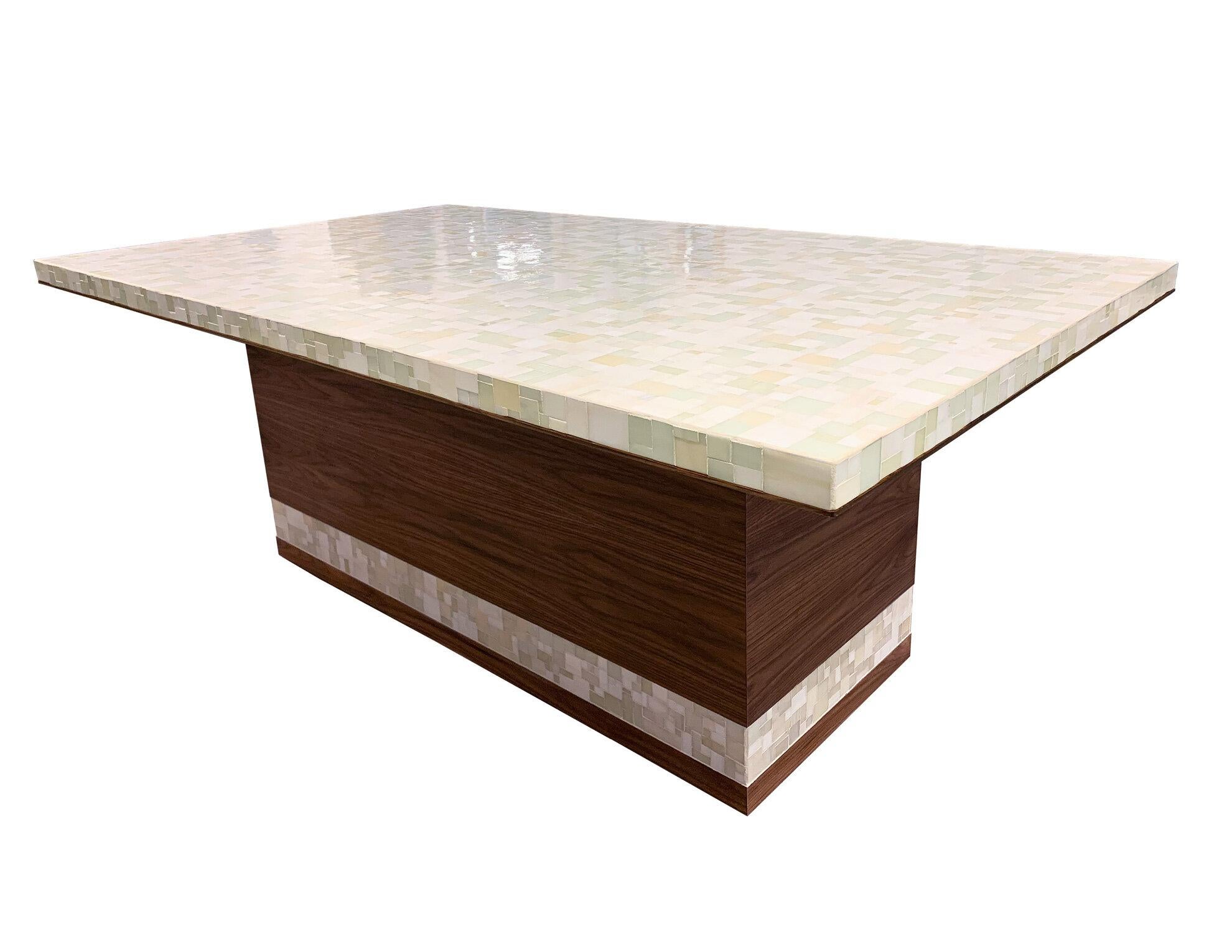 The Modern Mondrian Walnut Dining Table by Ercole Home is crafted from Walnut with a Natural Finish, with a pedestal base and Mondrian Pattern mosaic tabletop in a mix of Ivory glass. Custom sizes and finishes are available. 

Made in Brooklyn.
