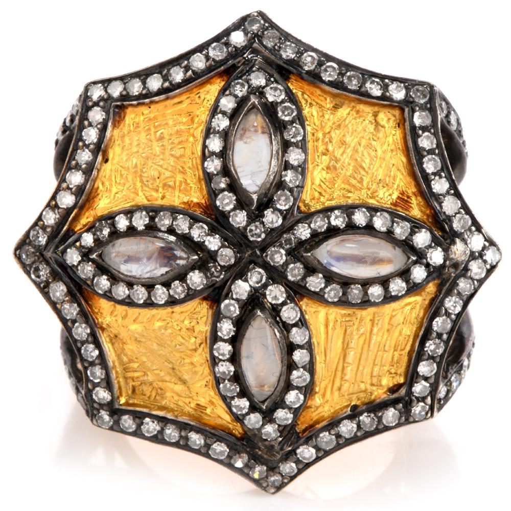 This fanciful Estate octagonal-shaped large cocktail ring crafted in 14K yellow gold features fine textural details on top and the back of the band.

The ring is centered with four marquise cabochon Moonstones showcasing beautiful flashes of blues