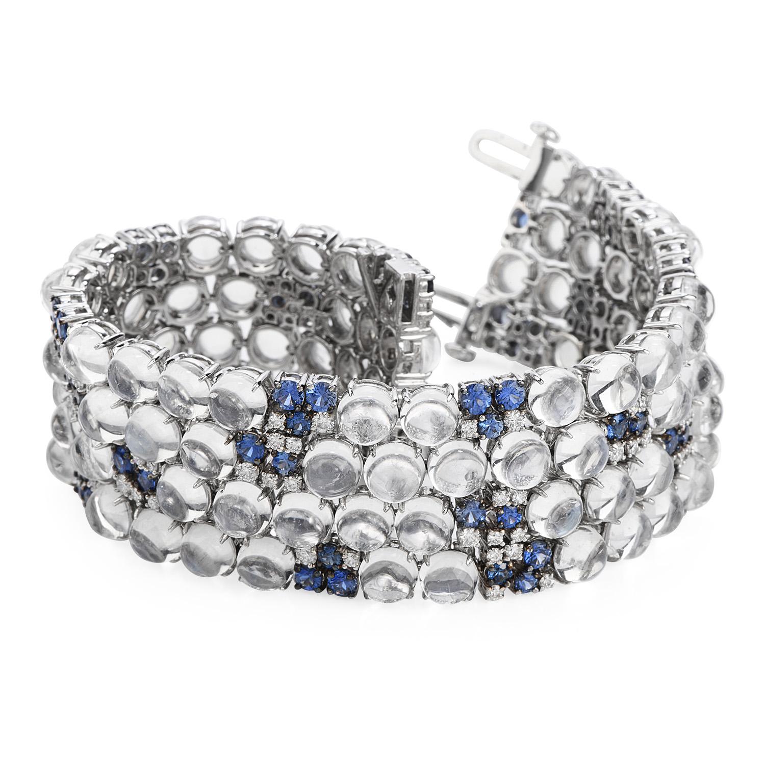 Adorn your arm and complete the look with this 

Statement, Estate, Circa 1980 wide bracelet.  

Crafted in 18K white gold, the intricate pattern has woven throughout both round cabochon cut moonstone, 

Amidst the royal blue silky color with icy