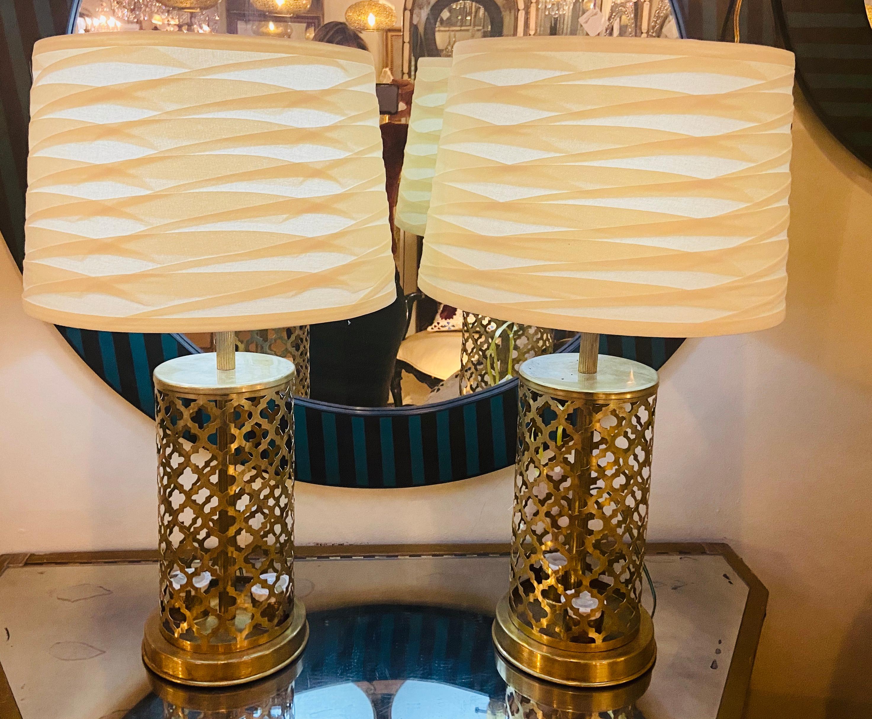 Modern Moroccan gold brass table lamp handmade with bottom and upper light, a pair
This pair of lamps is made of  fine brass and hand-tooled in an elegant and modern Moorish design. Each lamp features two bottom lights and upper light which enables