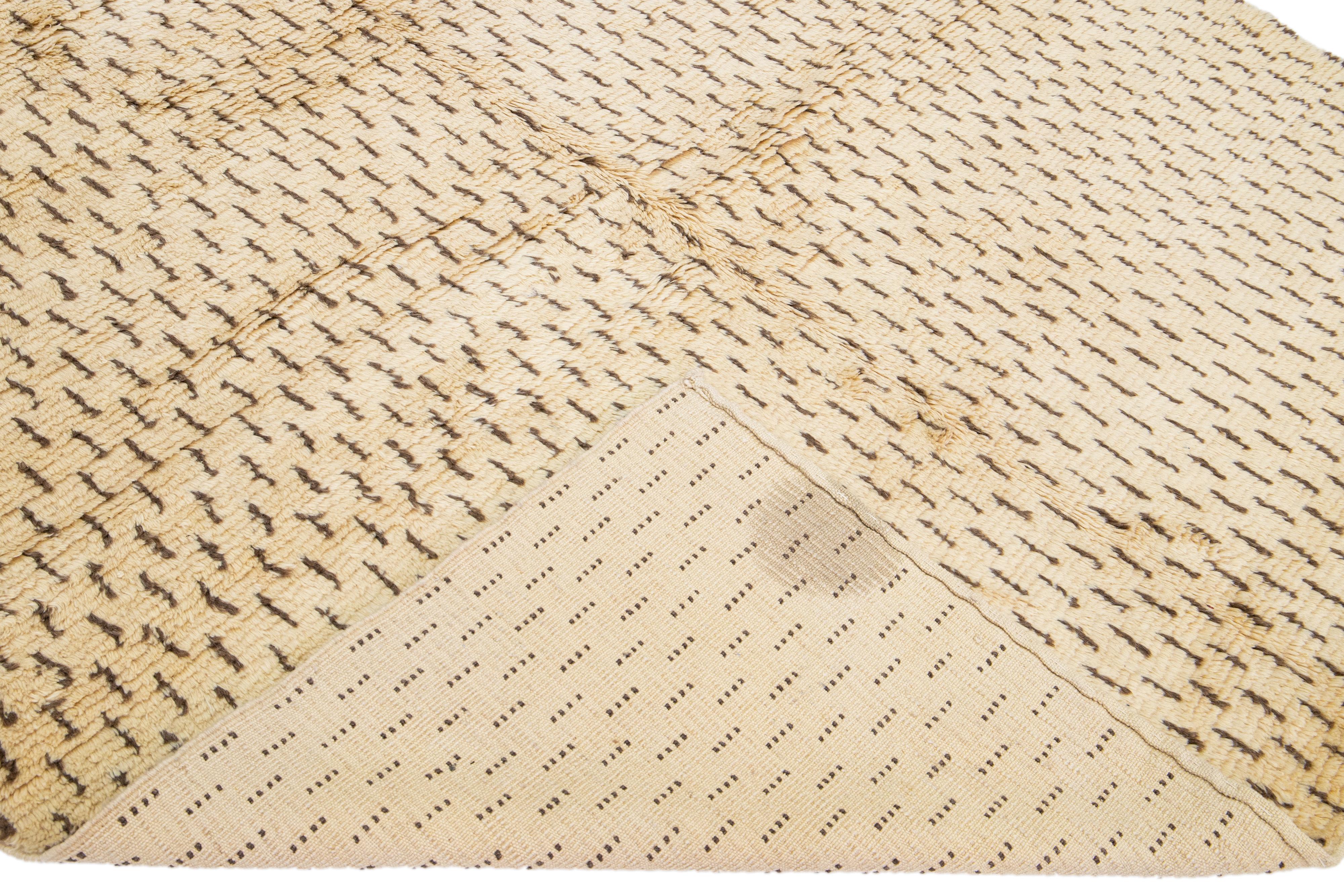 Beautiful modern Moroccan style hand-knotted wool rug with an antique tan-beige field in an all-over geometric abstract design.

This rug measures: 7'1