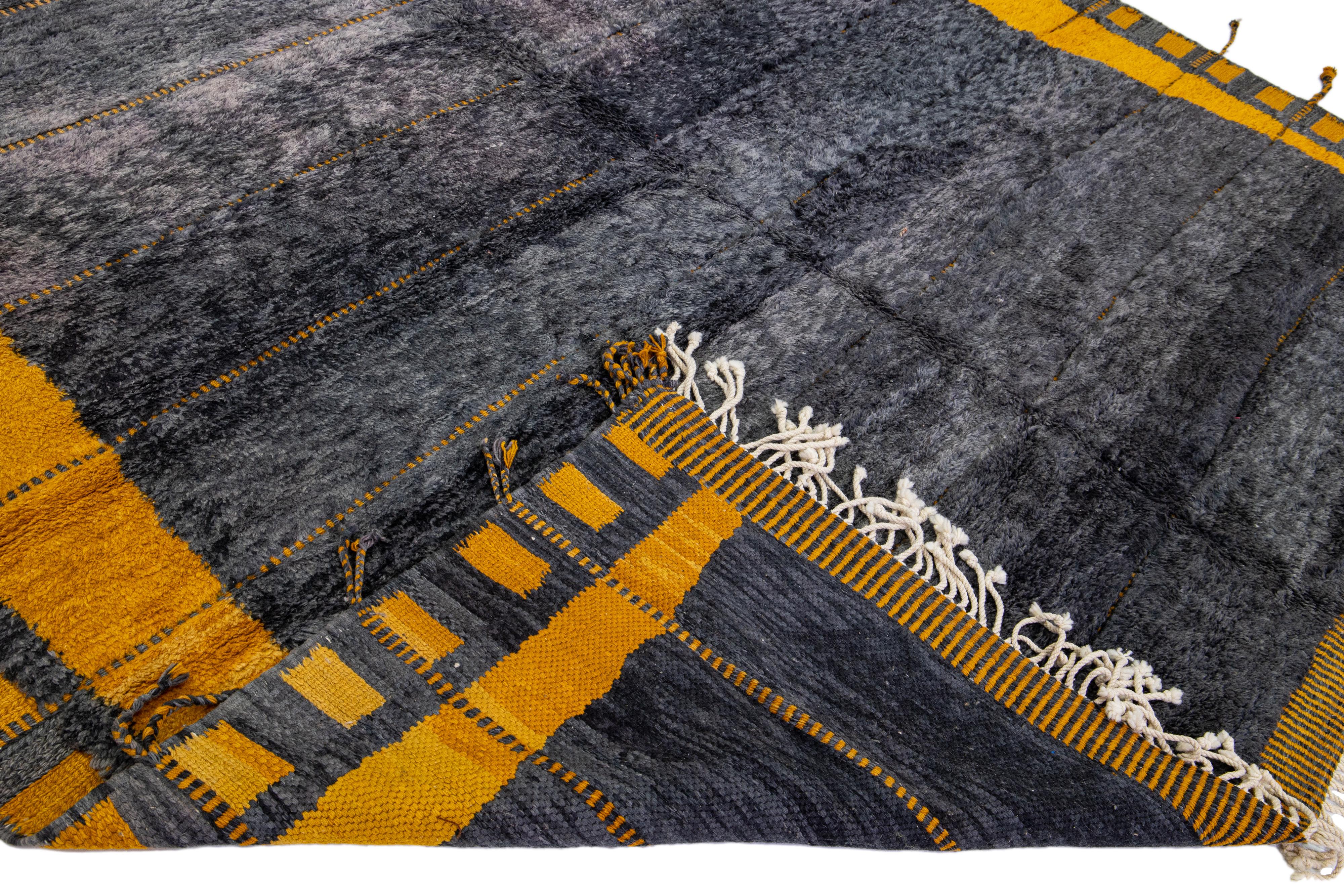 Beautiful Moroccan hand-knotted wool rug with a gray field. This Modern rug has yellow accent color and beige fringes in a gorgeous Geometric pattern design.

This rug measures: 11'4