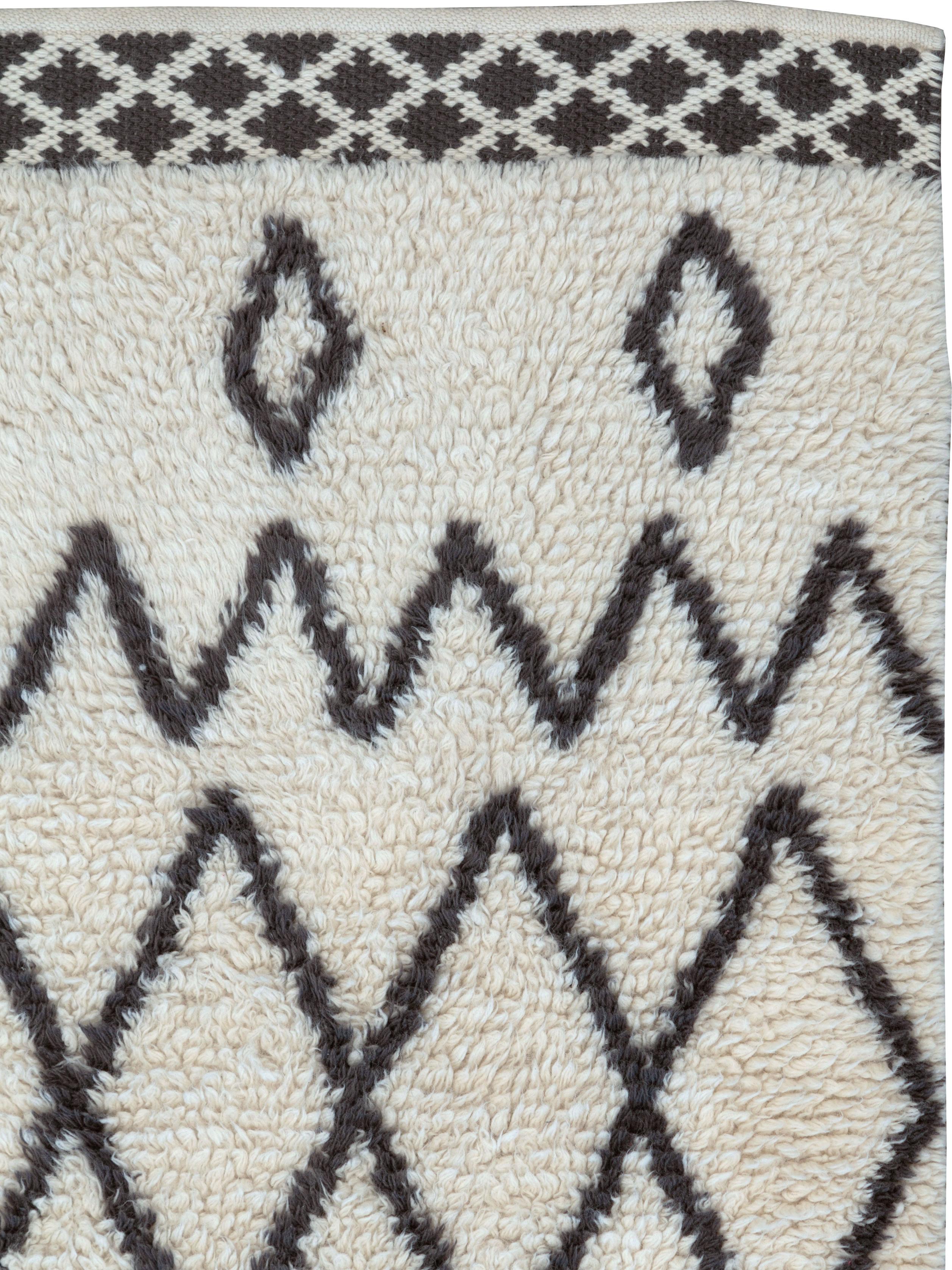 A modernist Moroccan throw rug in the style made famously by the Beni Ourain nomadic tribe from the Atlas Mountains.