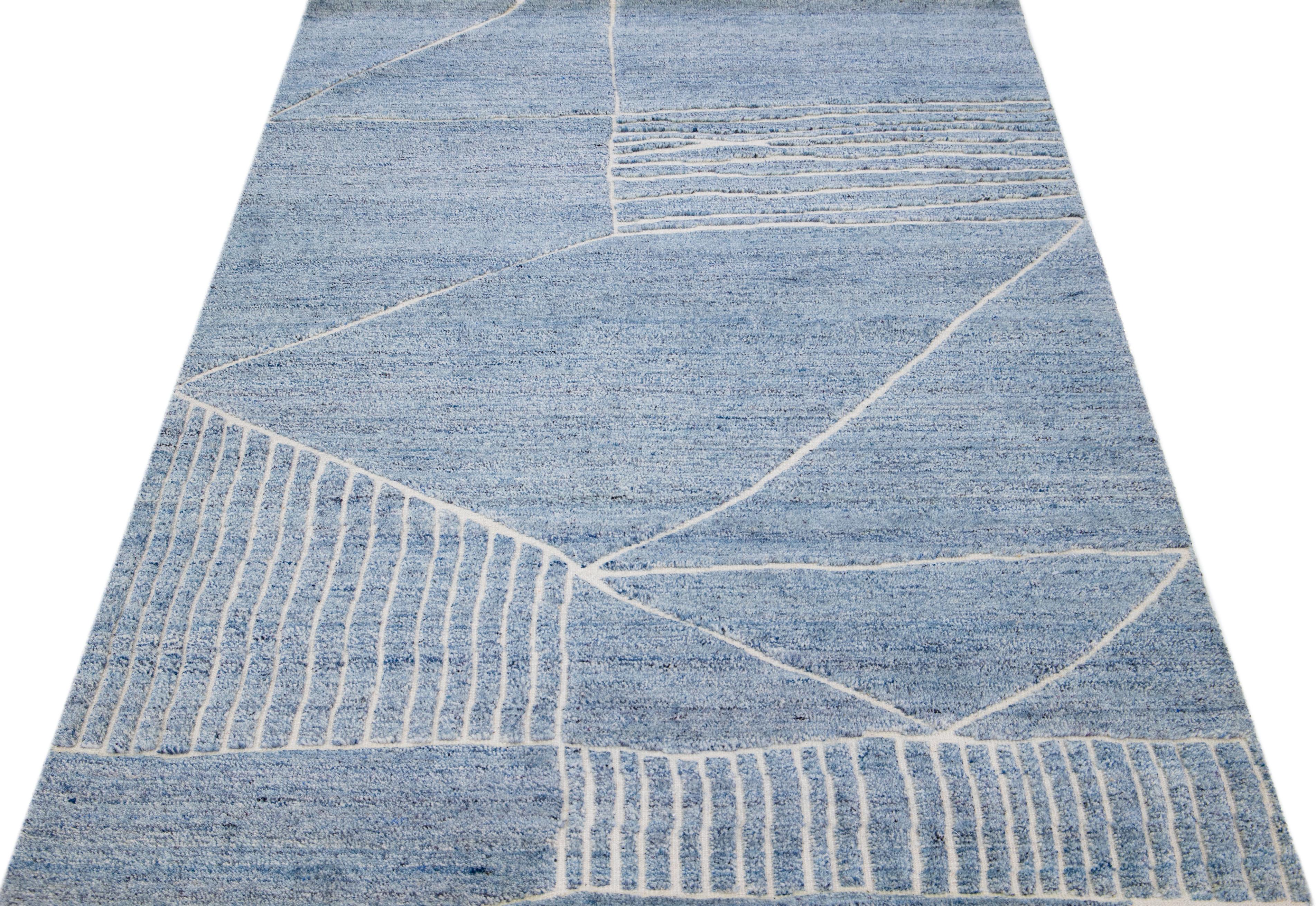 Beautiful modern Moroccan-style hand-knotted wool rug with a light blue color field. This rug is part of our Apadana's Safi Collection and features a geometric design in white.

This rug measures: 5'1