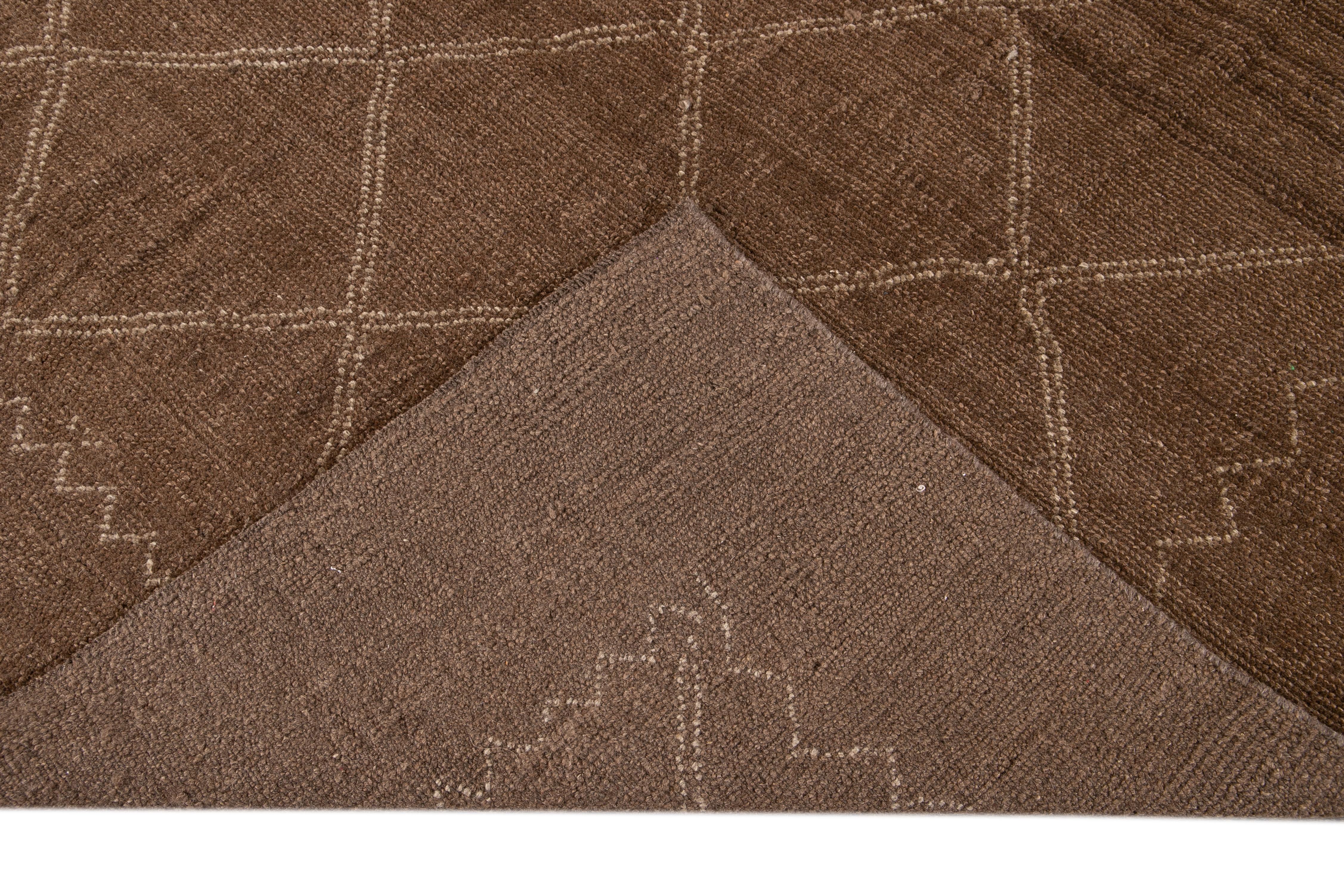 Beautiful contemporary Moroccan style hand-knotted wool rug with a brown field. This Moroccan rug has a beige accent in a gorgeous geometric diamond pattern design.

This rug measures 7' x 9'.

