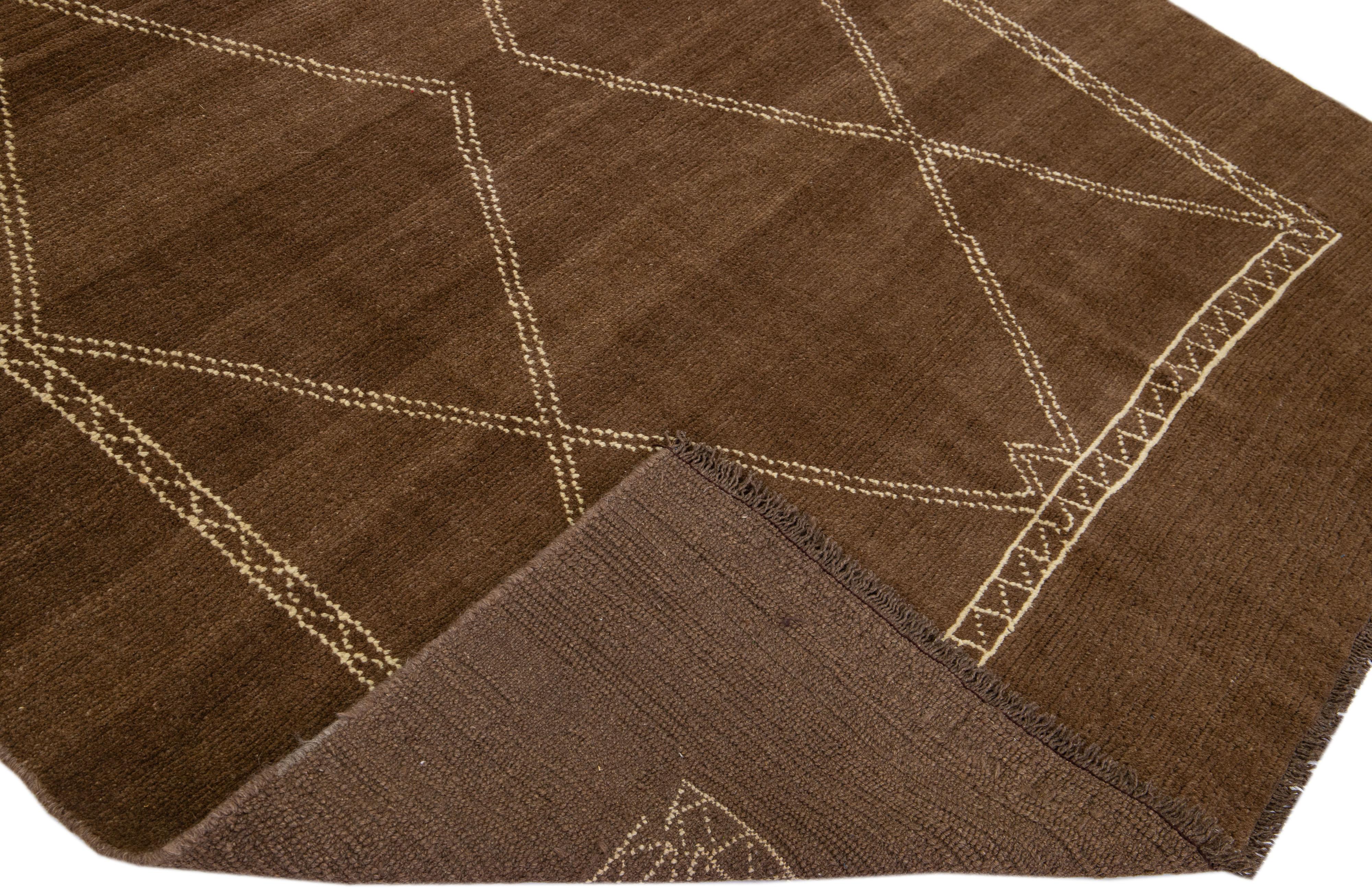 This Beautiful Moroccan-style handmade wool rug makes part of our Northwest collection and features a brown color field and beige accents in a gorgeous geometric tribal design.

This rug measures: 6'5