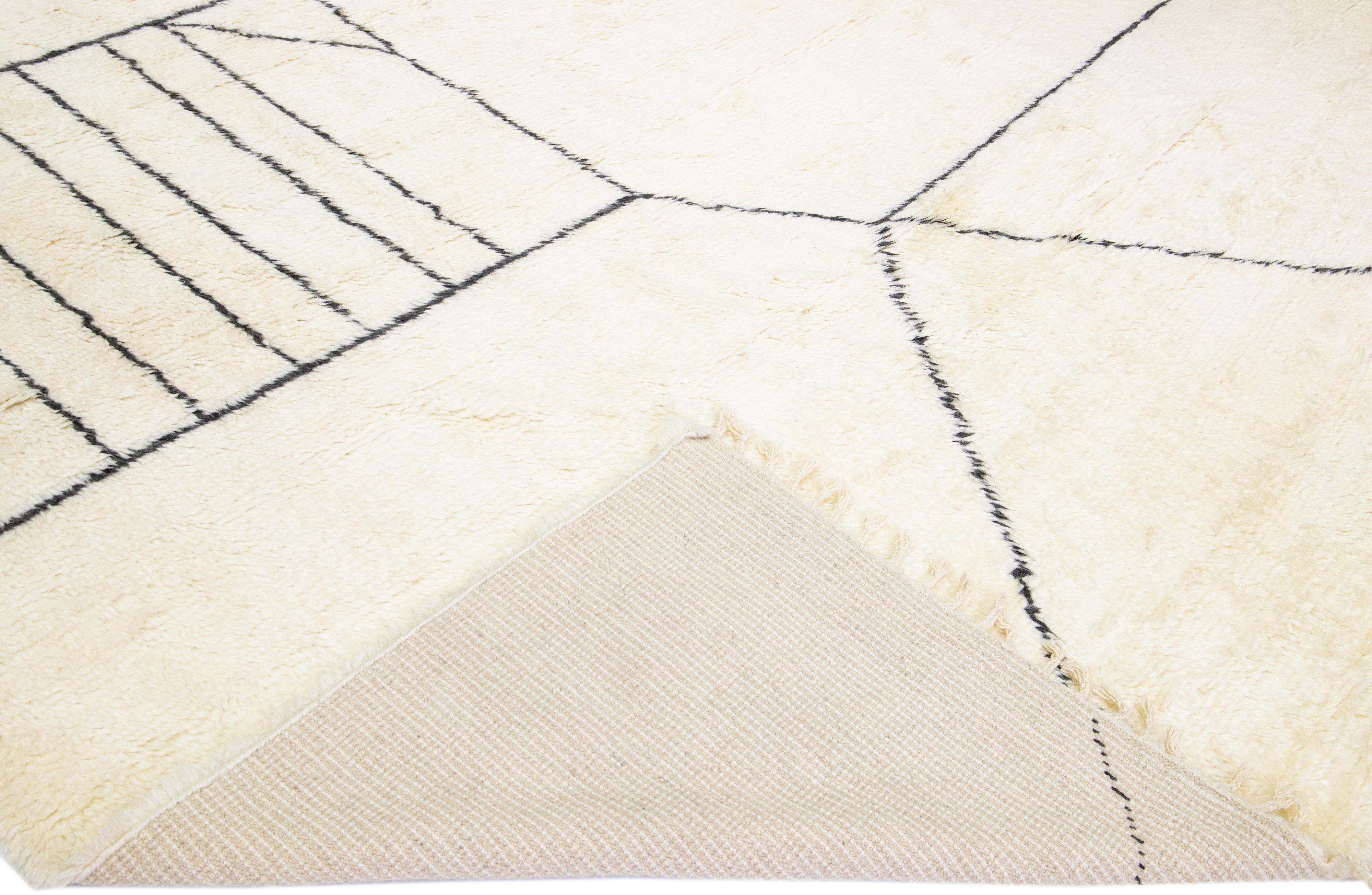 Beautiful modern Moroccan style hand-knotted wool rug with a white field and fringes in a gorgeous geometric abstract high pile design.

This rug measures: 12'1