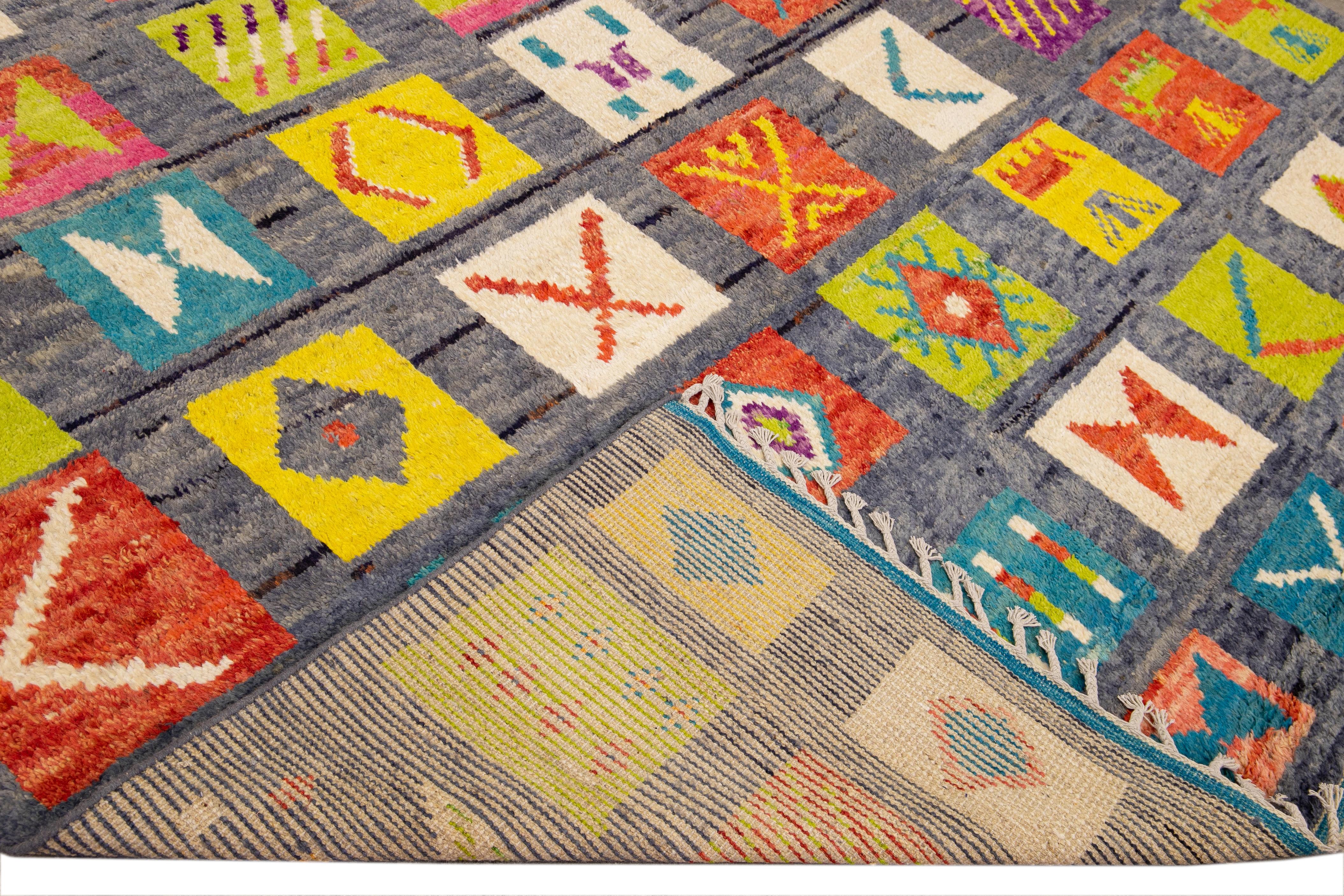 Beautiful Moroccan style handmade wool rug with a blue field. This Modern rug has multicolor accents and beige fringes featuring a gorgeous all-over boho tribal design.

This rug measures: 9'10