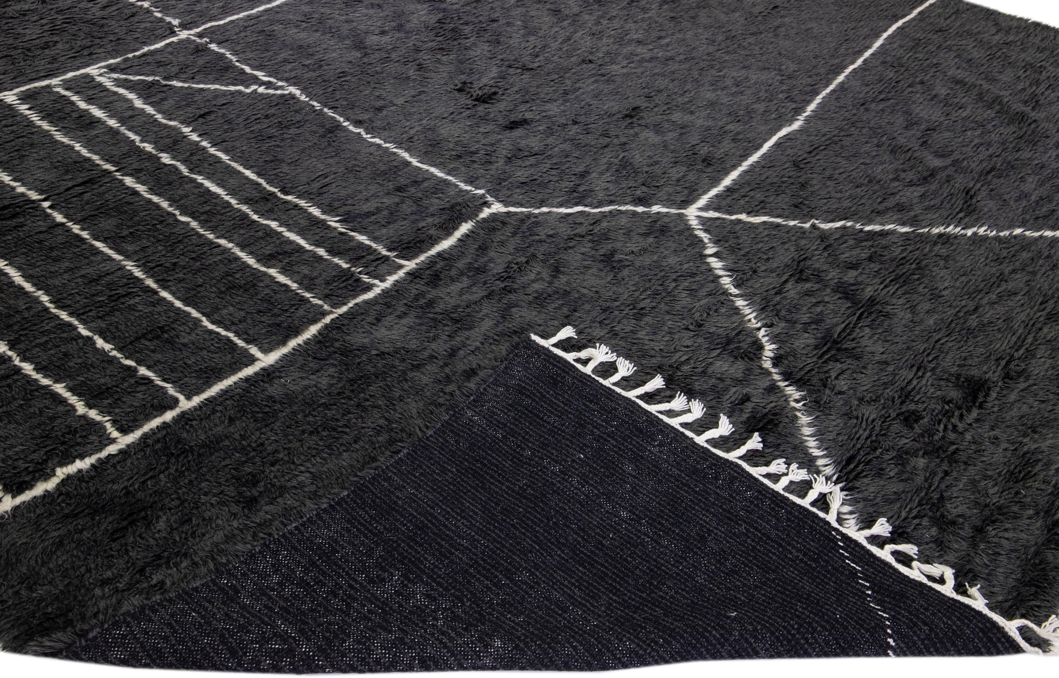 Beautiful modern Moroccan style hand-knotted wool rug with a black field and white fringes in a gorgeous geometric abstract high pile design.

This rug measures: 12'1'' x 14'10''.

Our rugs are professional cleaning before shipping.