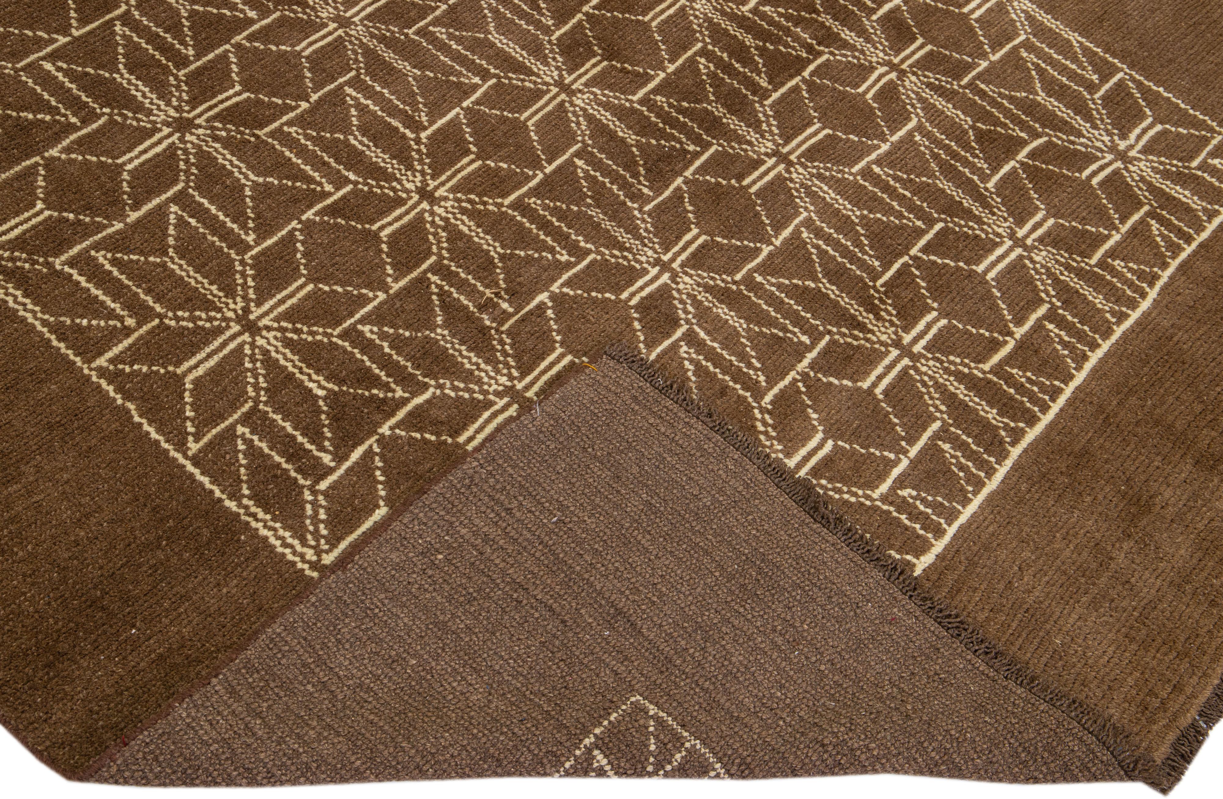 This Beautiful Moroccan-style handmade wool rug makes part of our Northwest collection and features a brown color field and beige accents in a gorgeous geometric tribal design.

This rug measures: 6'10