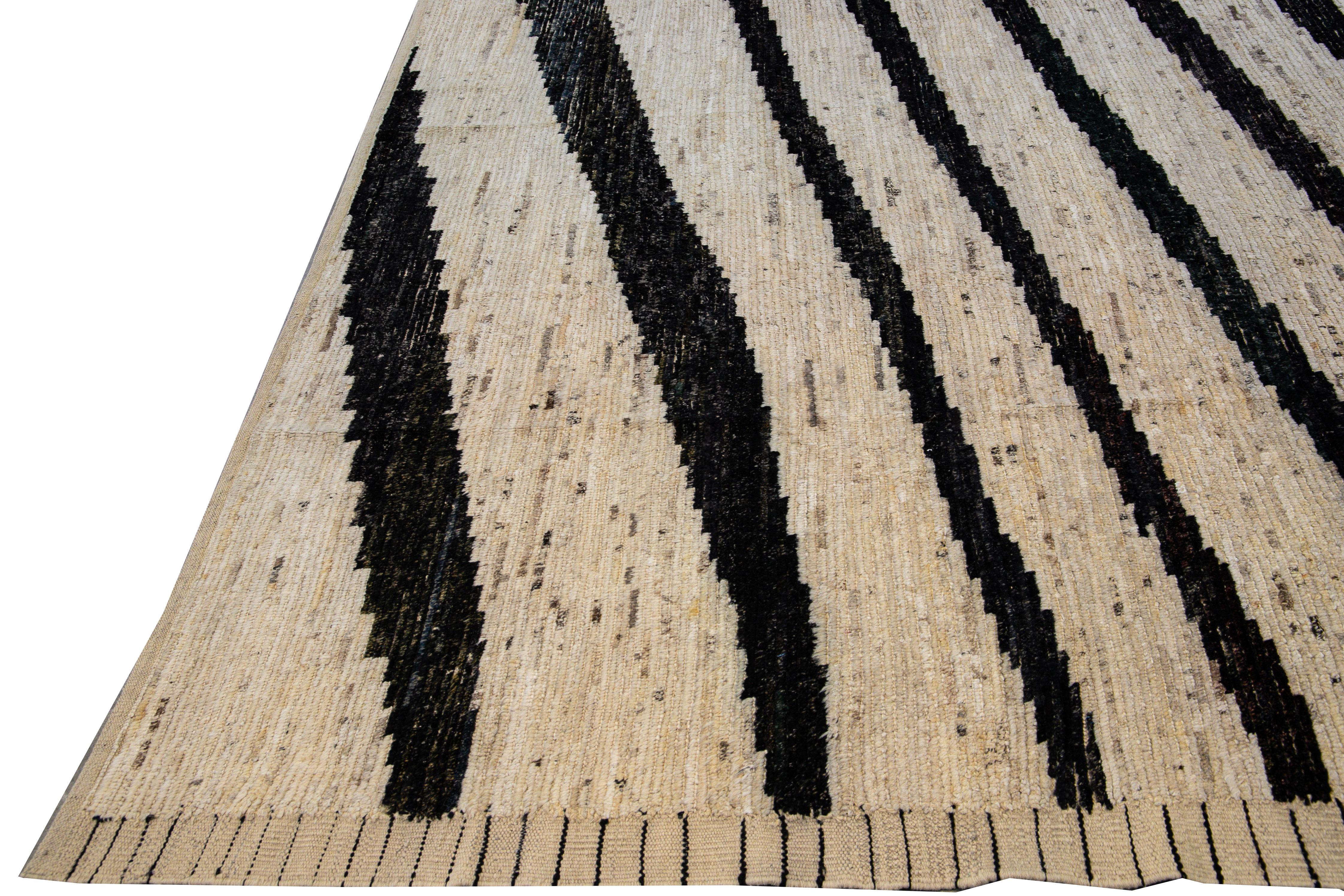 Beautiful Moroccan- Style handmade wool rug with a beige field. This Moroccan rug has a black accent featuring a gorgeous geometric Zebra Print design.

This rug measures: 13'7