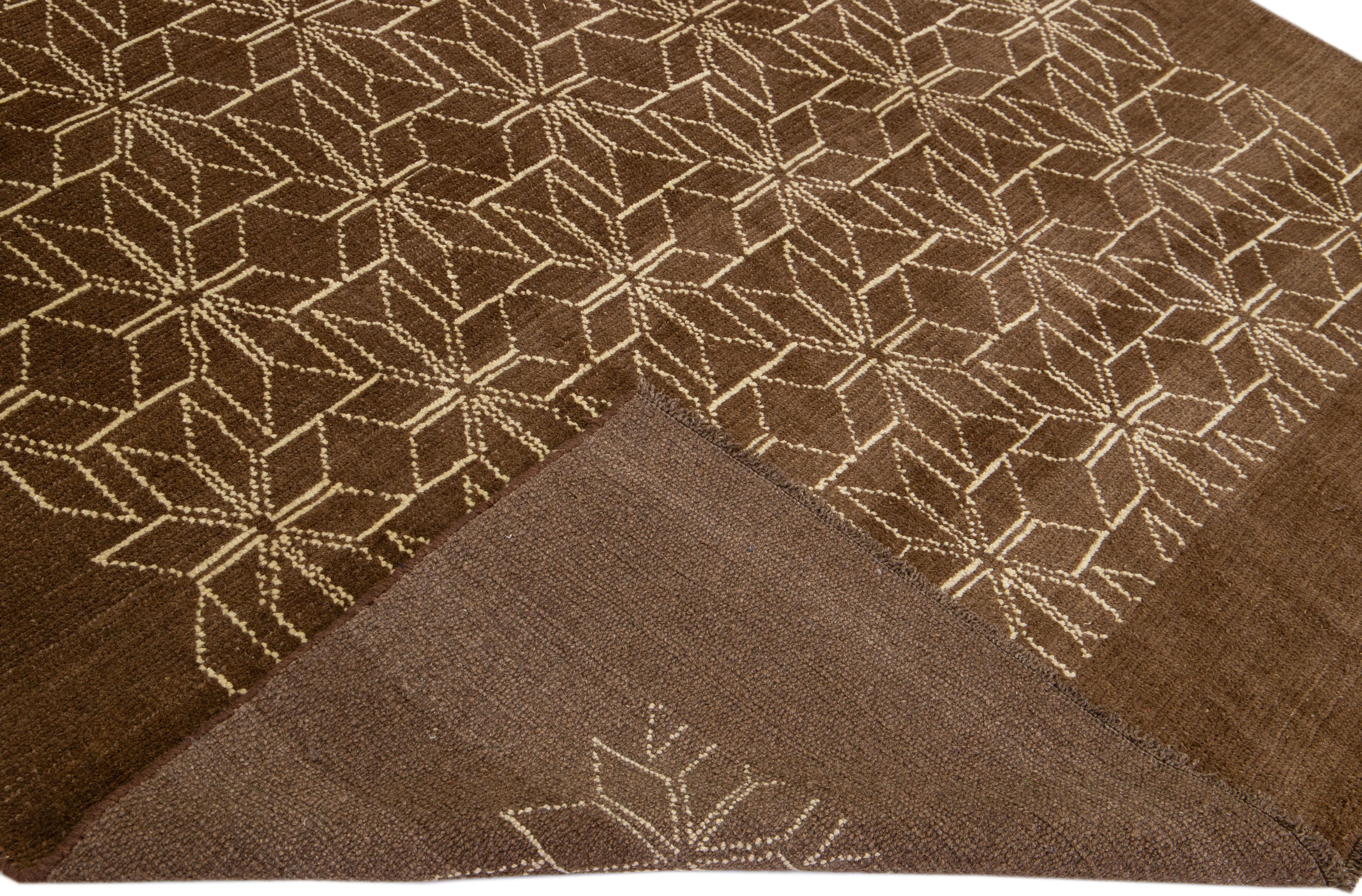 This Beautiful Moroccan-style handmade wool rug makes part of our Northwest collection and features a brown color field and beige accents in a gorgeous geometric tribal design.

This rug measures: 7'2